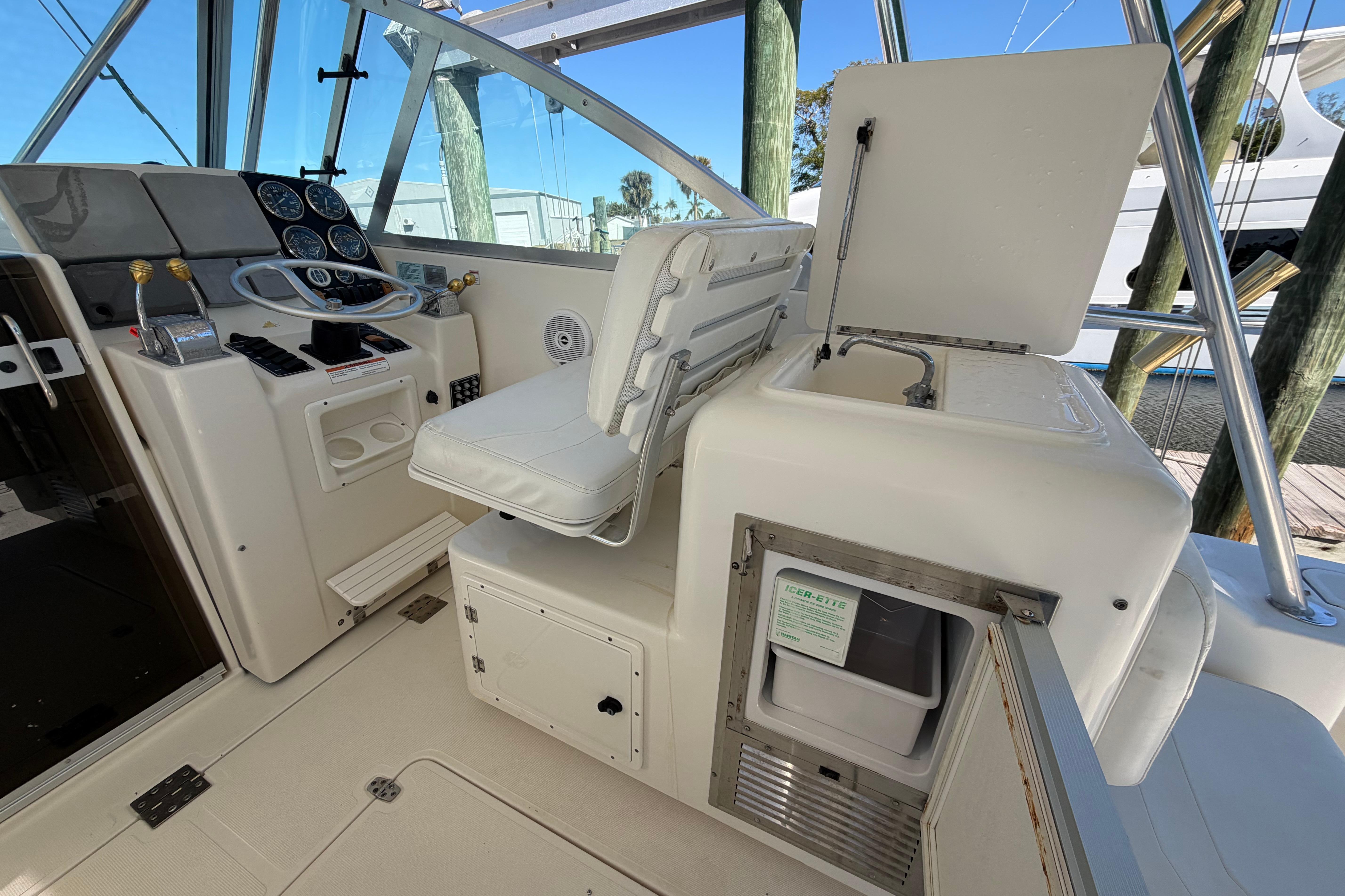 2001 Pursuit 3000 Express boat cockpit with helm, seating, and storage compartments.
