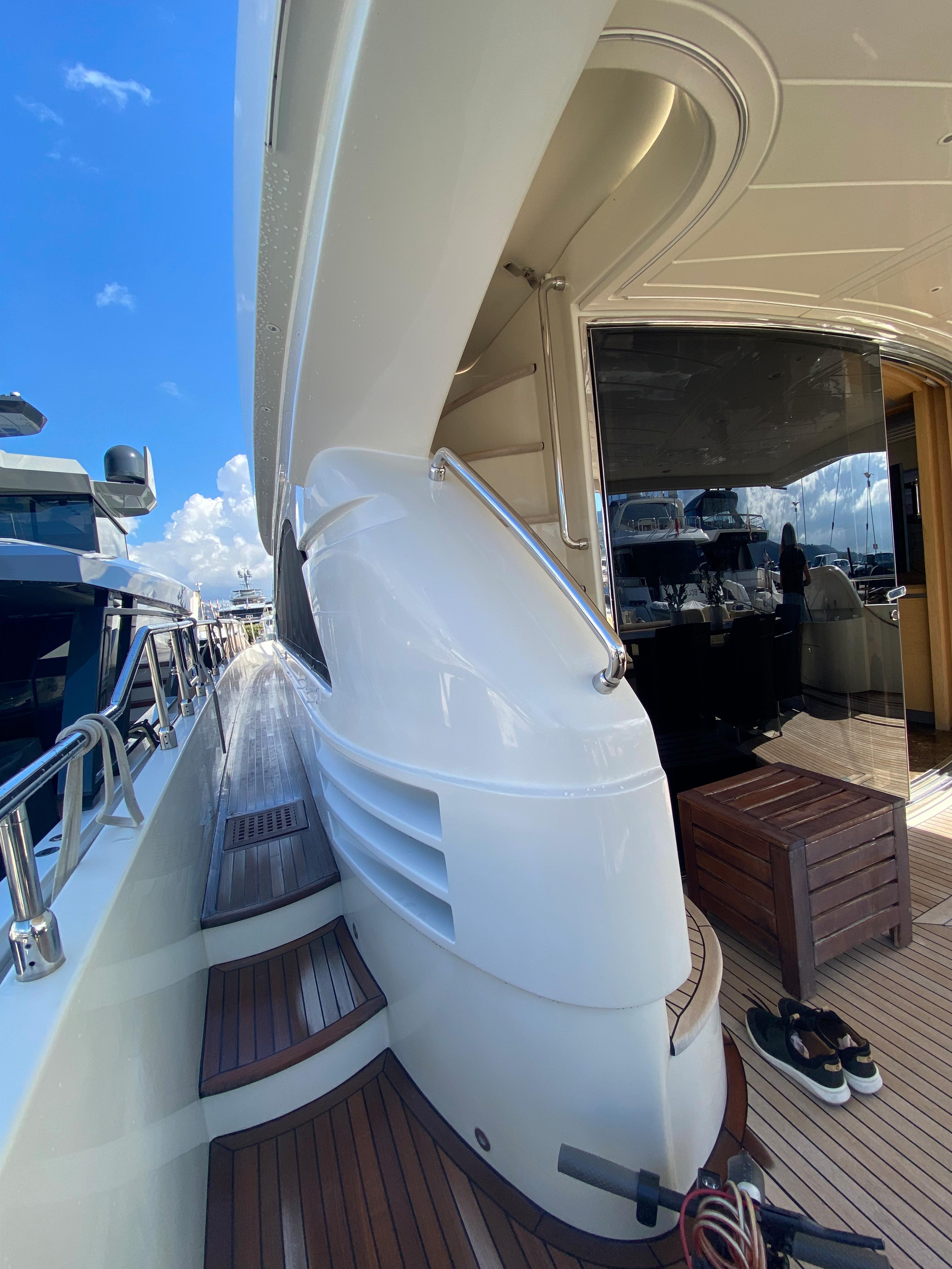 Luxury yacht deck of 2008 Dominator 680 with sleek design and wooden flooring.