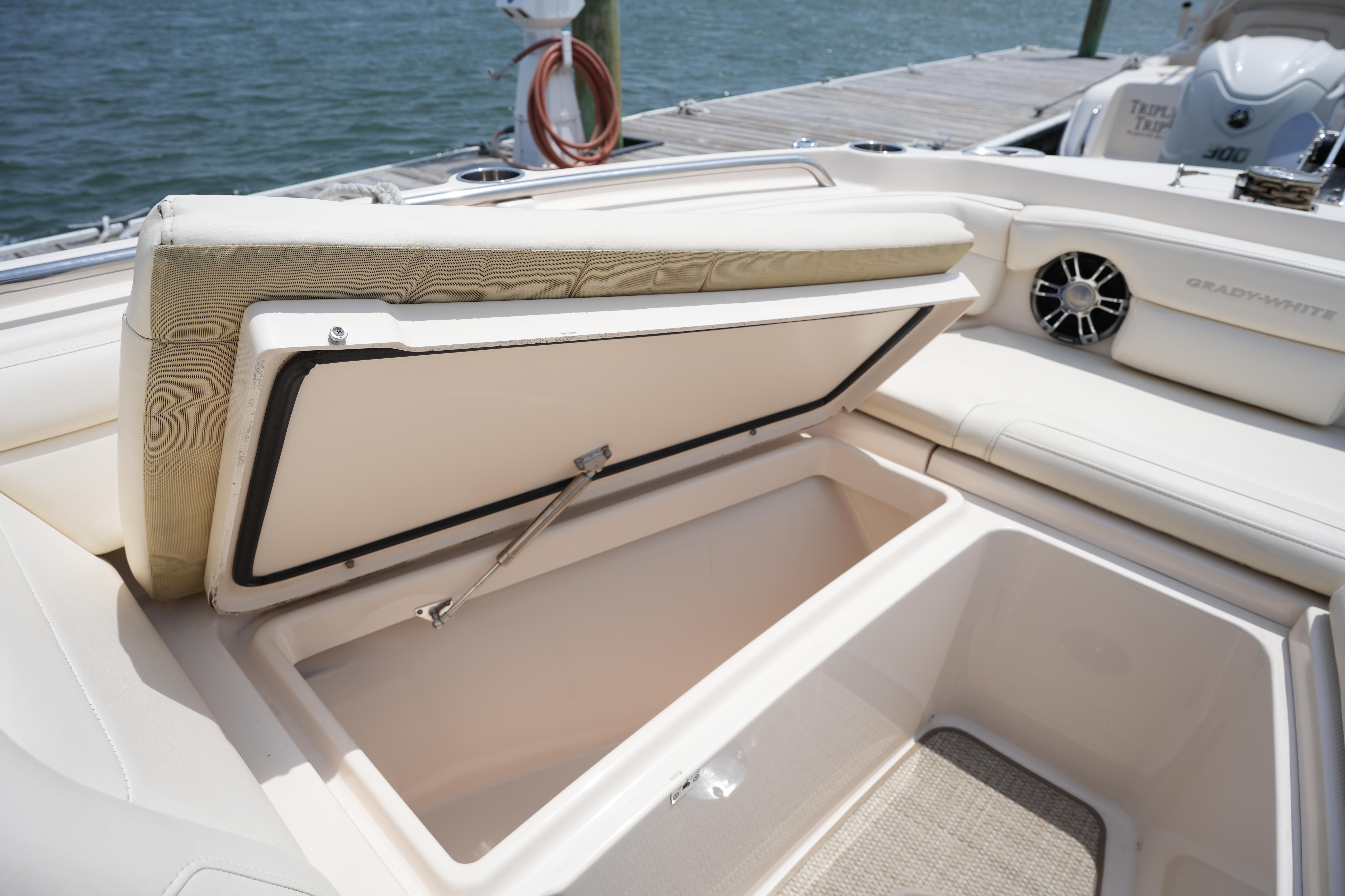 2021 Grady-White Freedom 235 boat with open storage compartment at dockside.