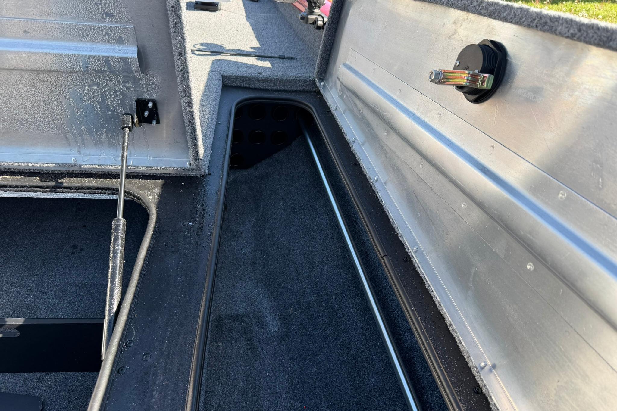 2024 Tracker Pro Team 175 TXW boat storage compartment with open lid and hydraulic support.