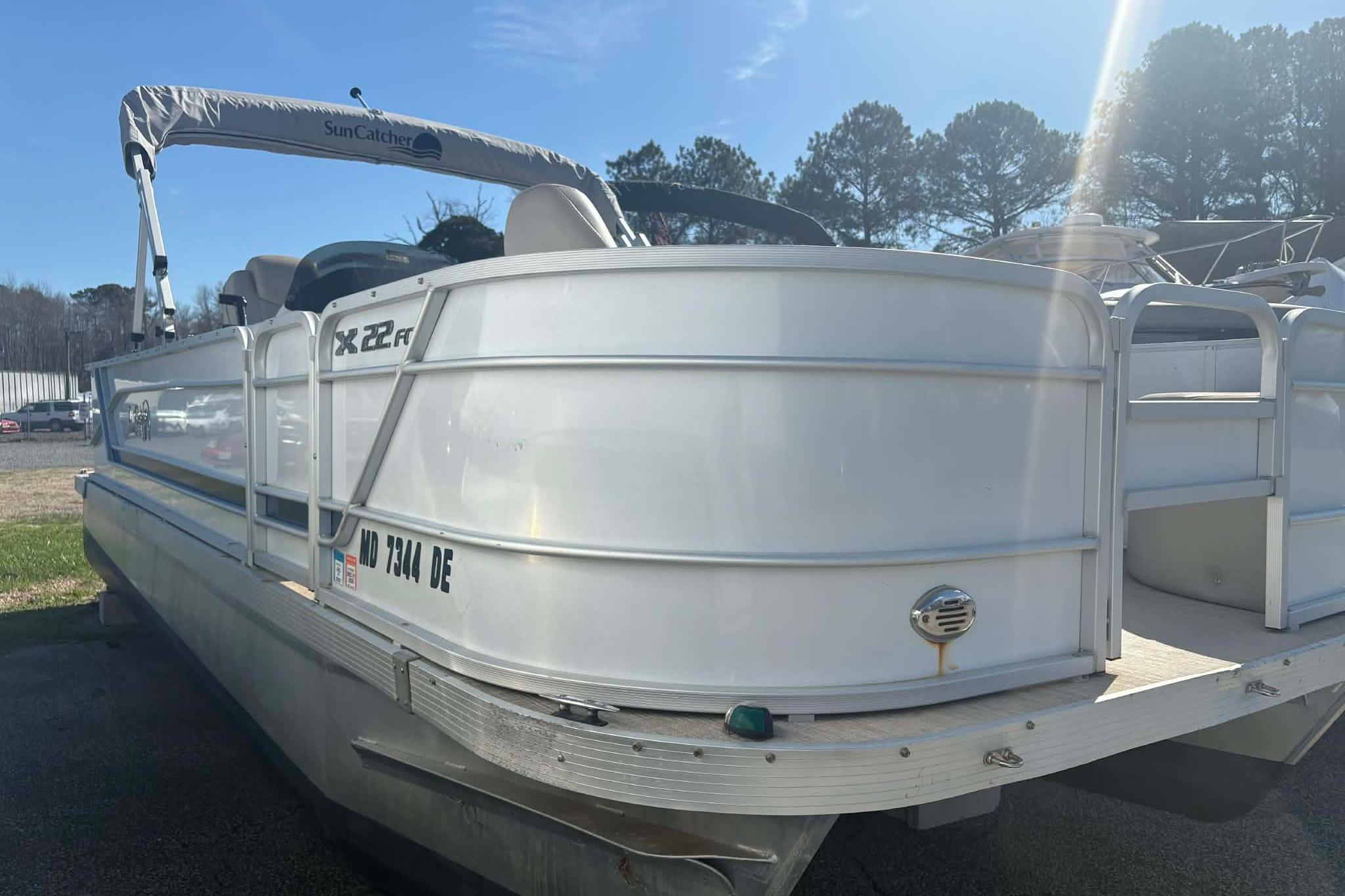 Pontoon boat G3 X22RF, 2017 model, docked under sunny skies.