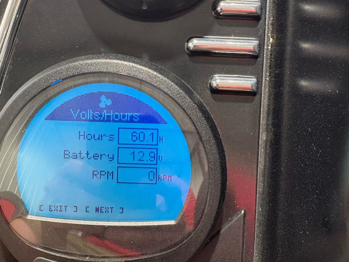 Close-up of a boat display showing hours, battery level, and RPM.