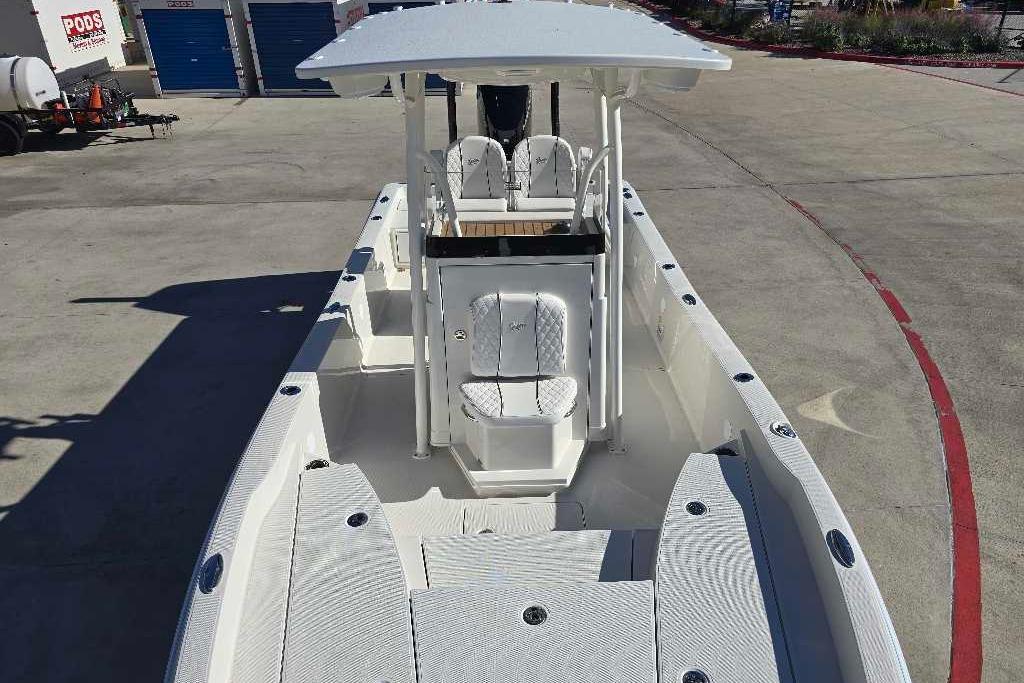 2025 Ranger 2510 Bay boat with spacious deck and seating, parked outdoors.
