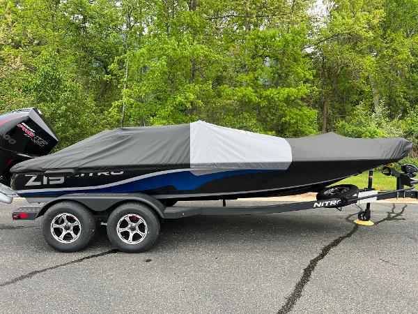 2025 Nitro Z19 Pro boat covered on a trailer, parked on a paved surface.