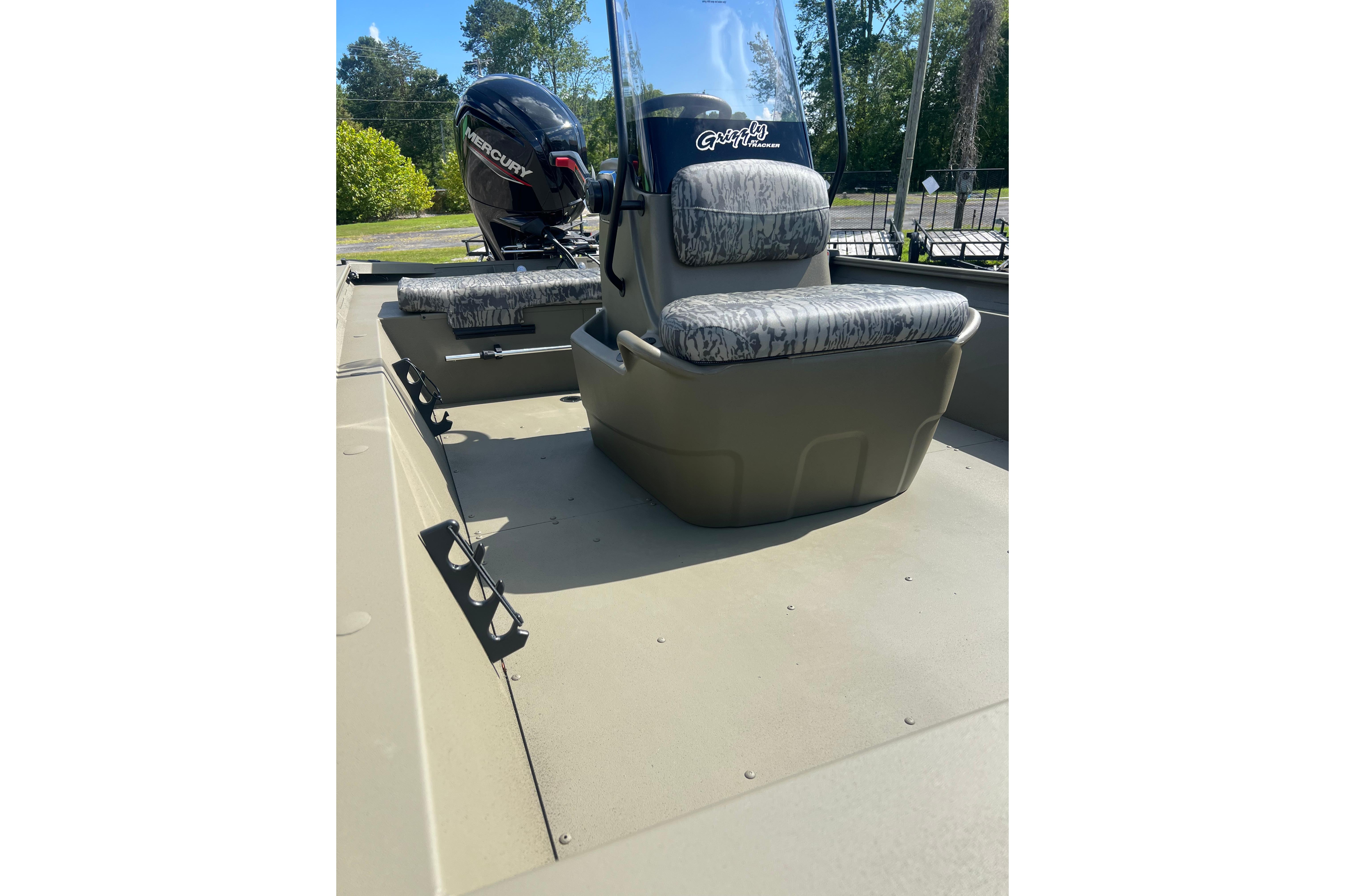 2026 Tracker Grizzly 1860 CC boat interior with camo seats and Mercury outboard motor.