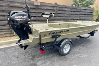 2026 Tracker Grizzly 1654 T Sportsman boat with Mercury engine on trailer.