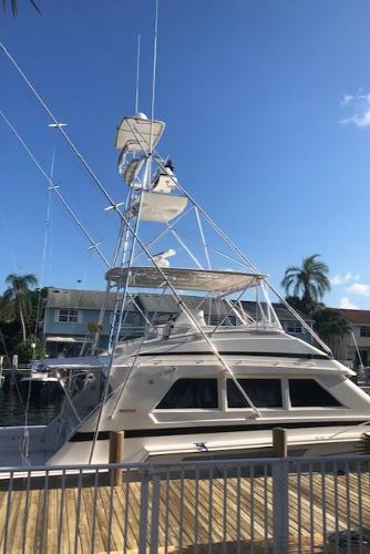 1997 Bertram Convertible yacht docked at a marina.
