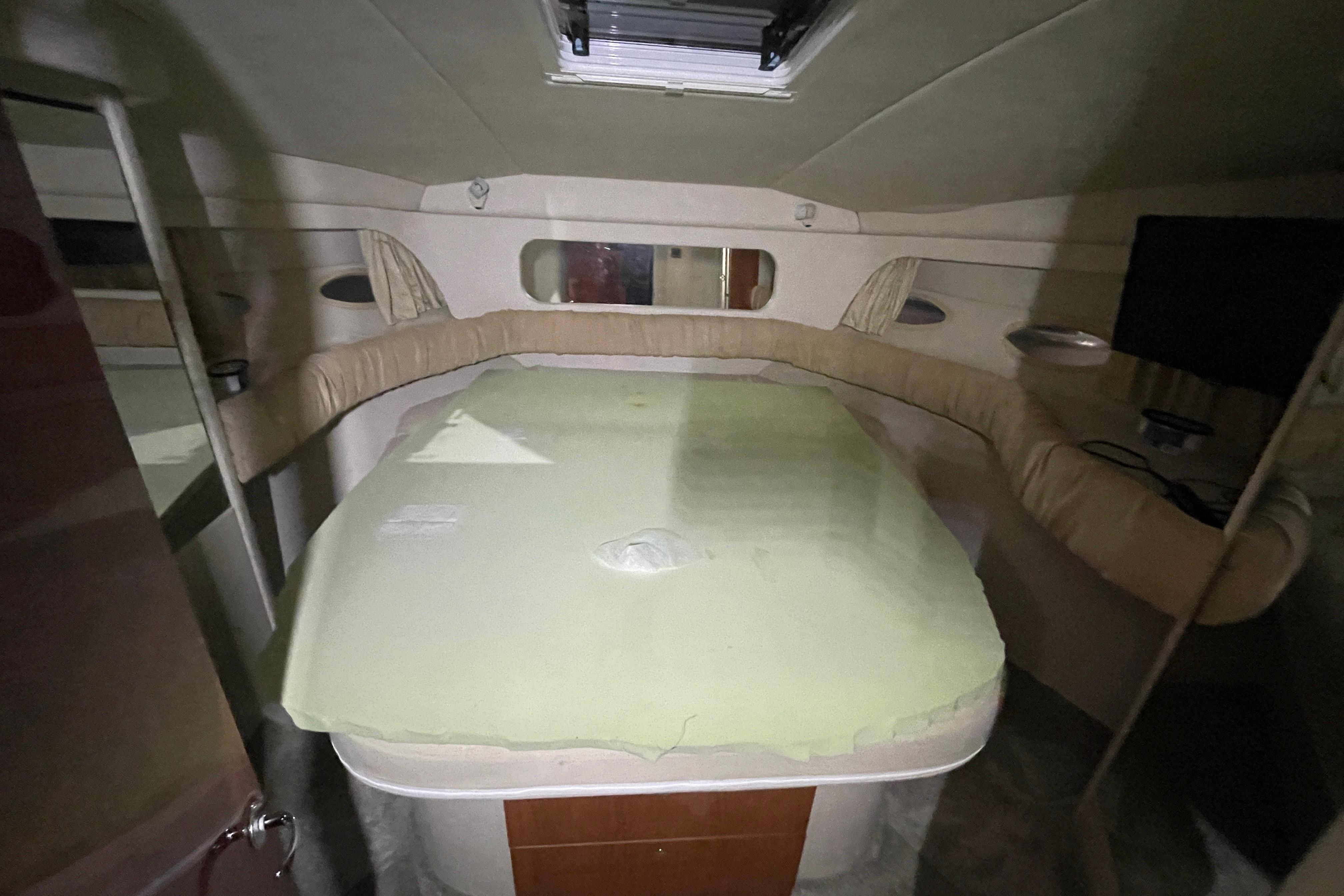Interior cabin of 2000 Sea Ray 380 Aft Cabin yacht, featuring a bed and seating area.