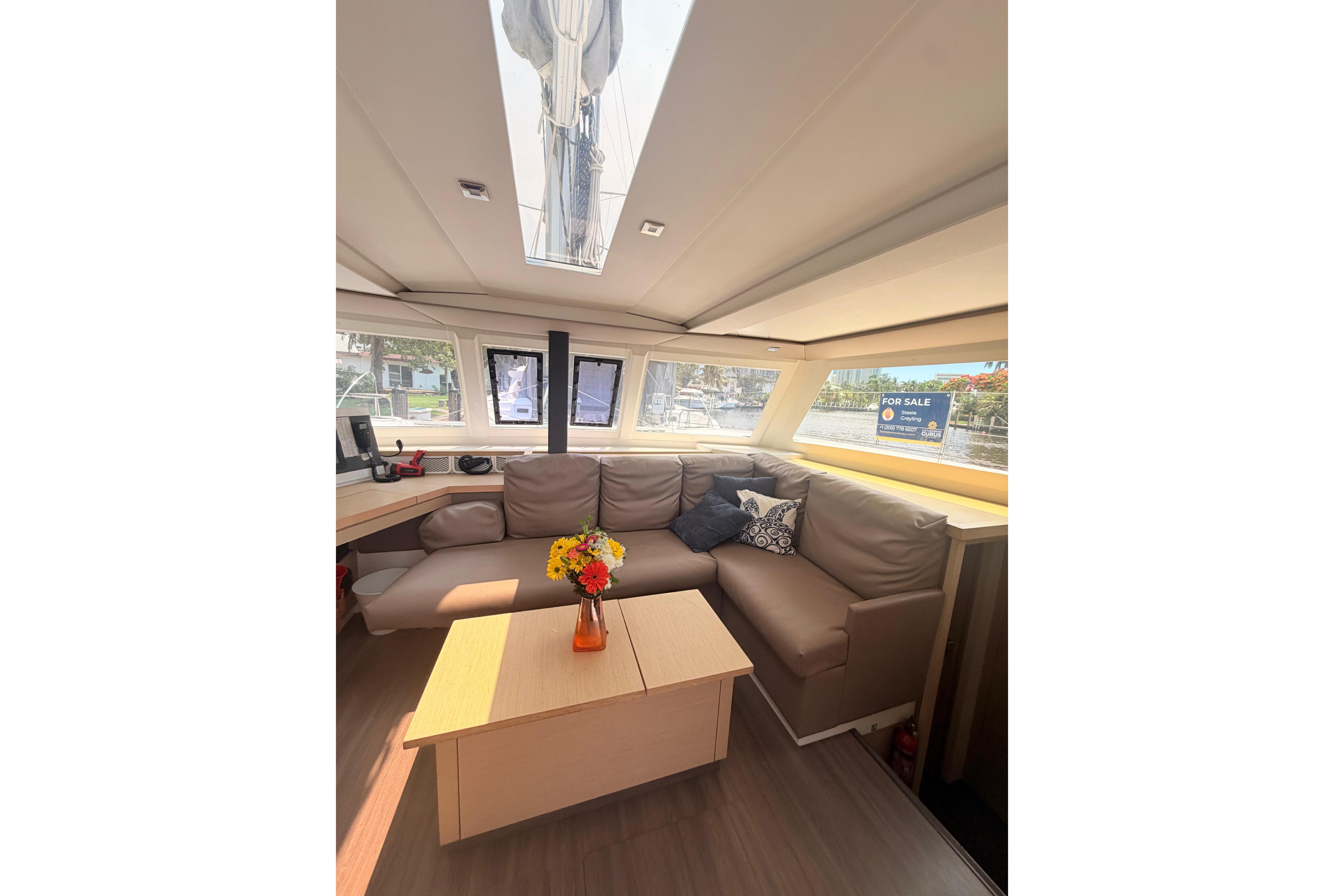 Interior of 2018 Fountaine Pajot Lucia 40 catamaran with cozy seating and table.