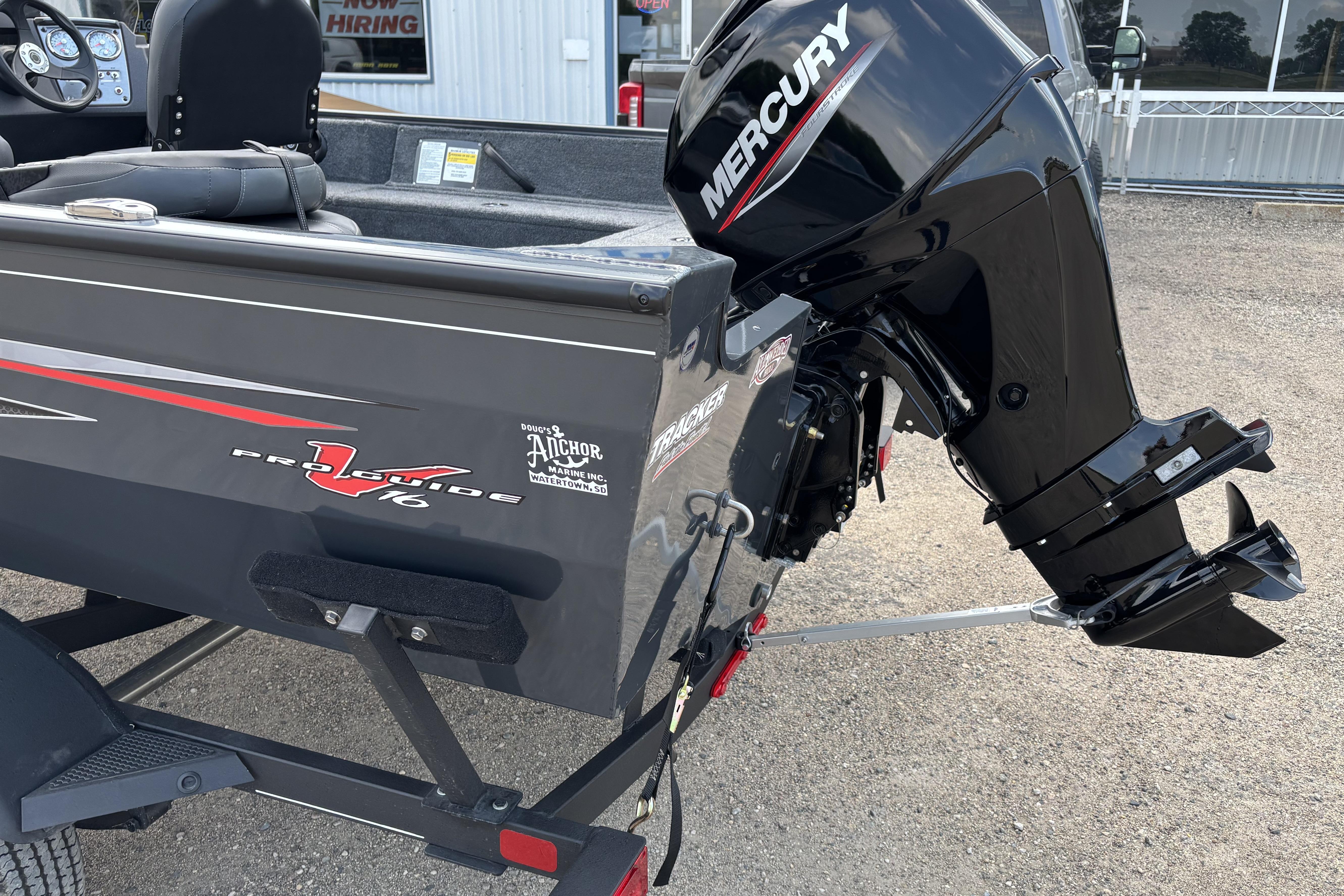 2021 Tracker Pro Guide V-16 WT boat with Mercury outboard motor, parked on a trailer.