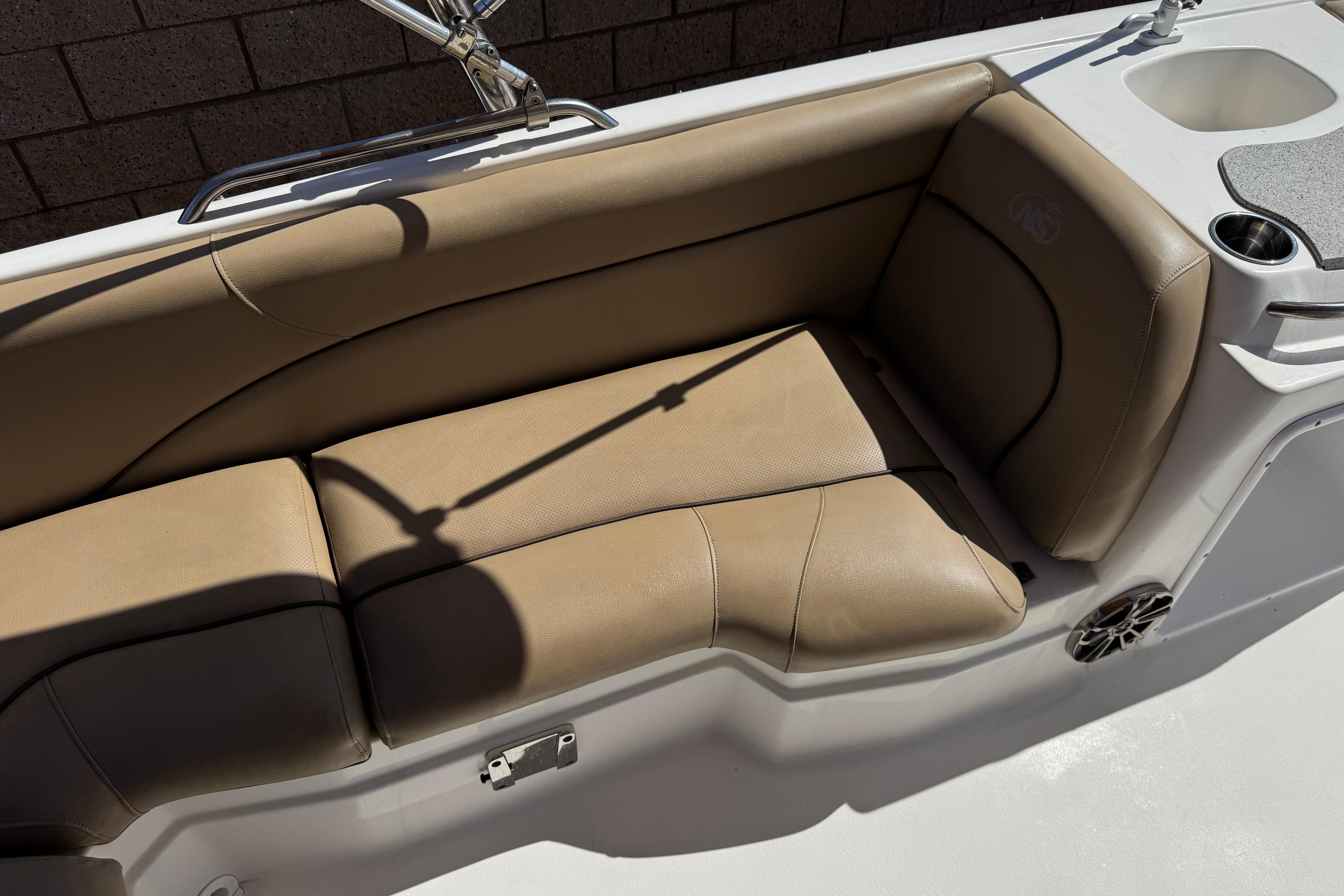 2020 NauticStar 203 SC boat interior with tan seating and cup holder.