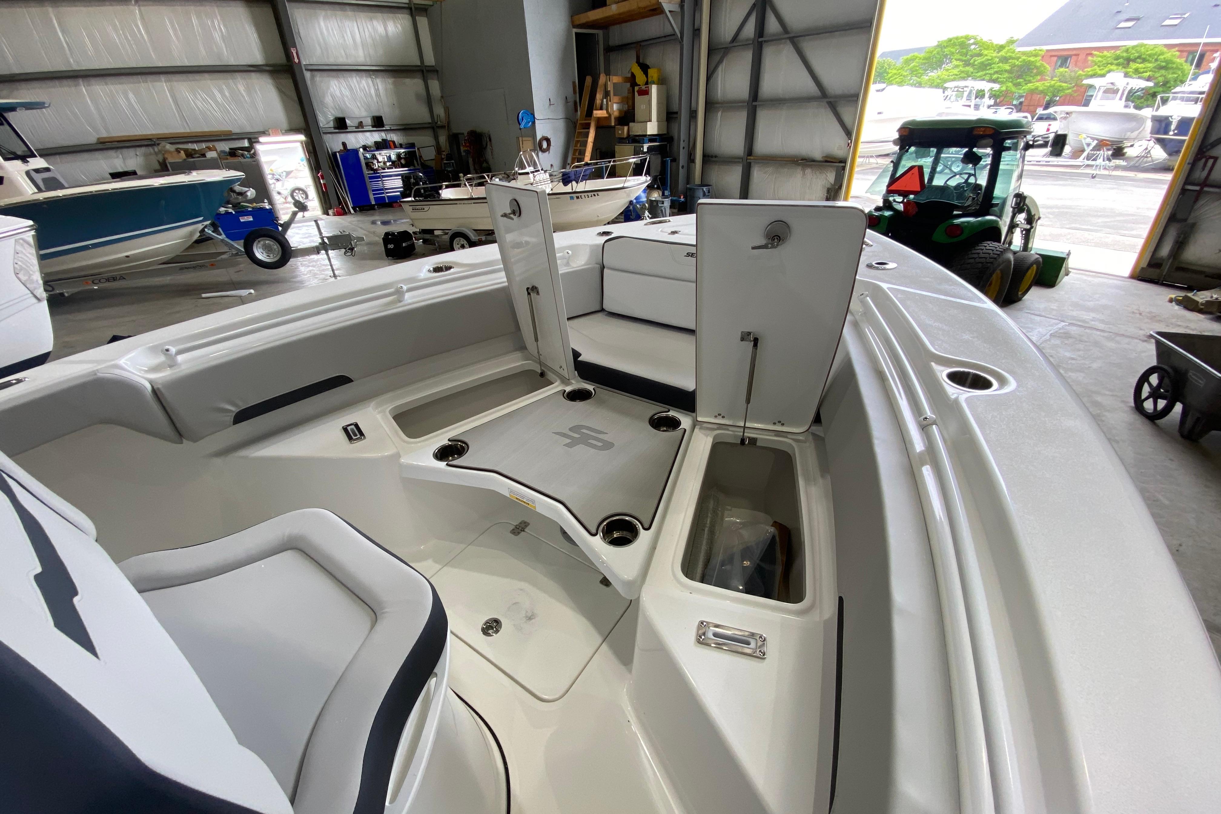 Interior view of 2027 Sea Pro 245FLXR Sandbar boat in a storage facility.