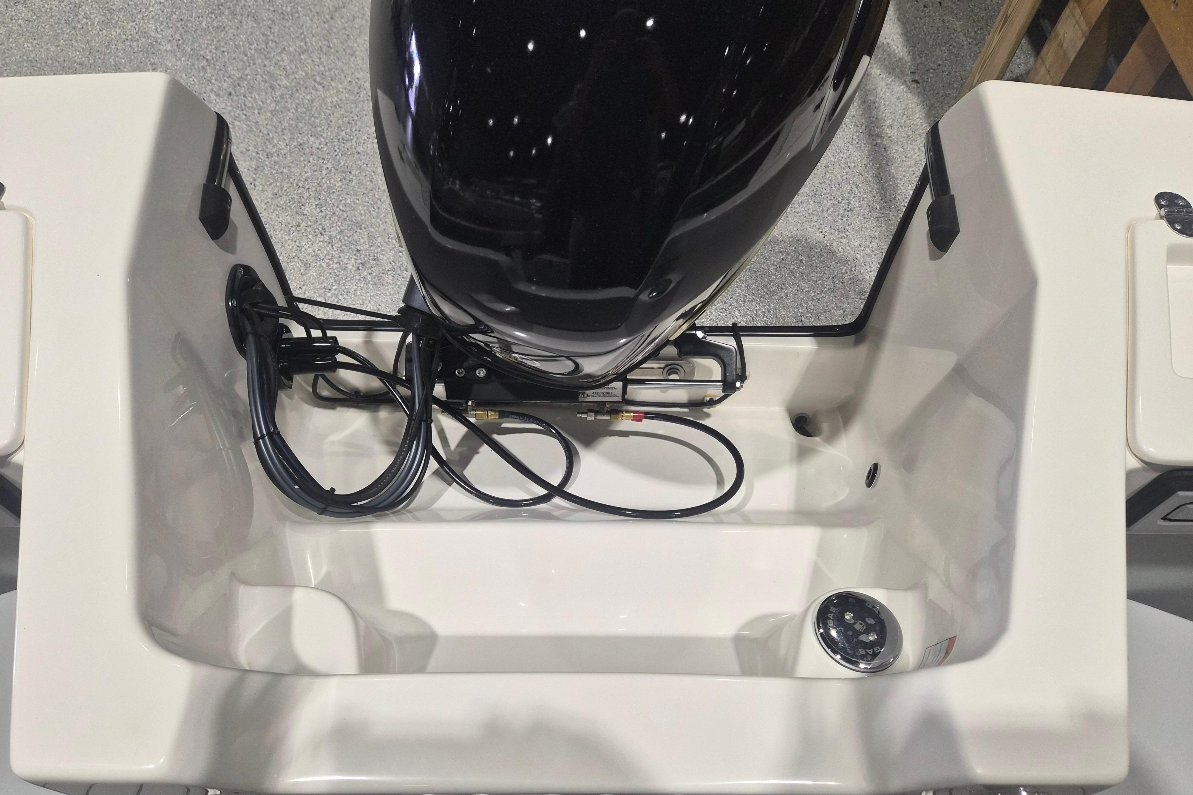 2026 Arima Sea Chaser 19 Yellowtail Edition boat engine compartment, showcasing cables and fittings.