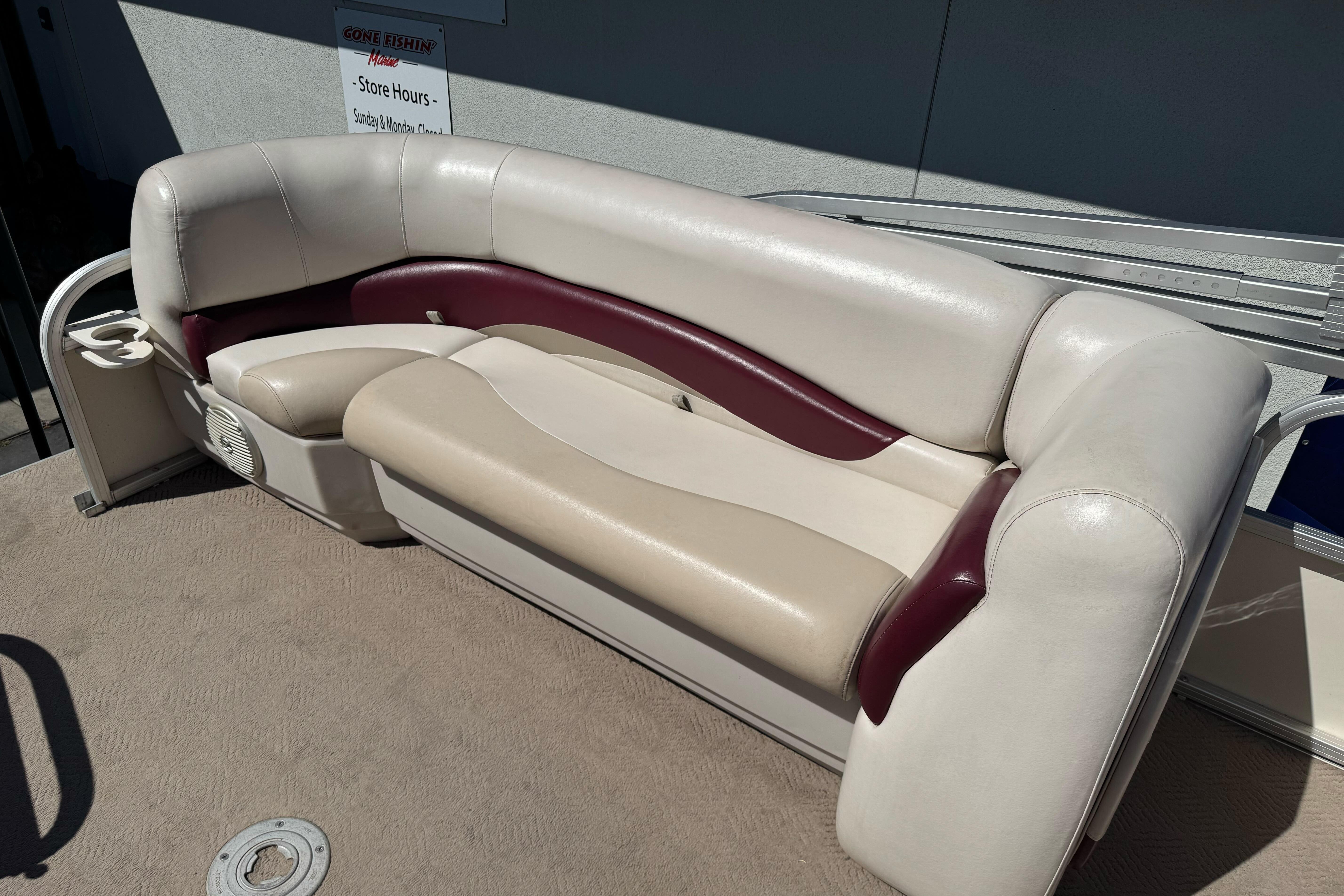 2011 Sun Tracker Party Barge 21 seating with beige and maroon upholstery.
