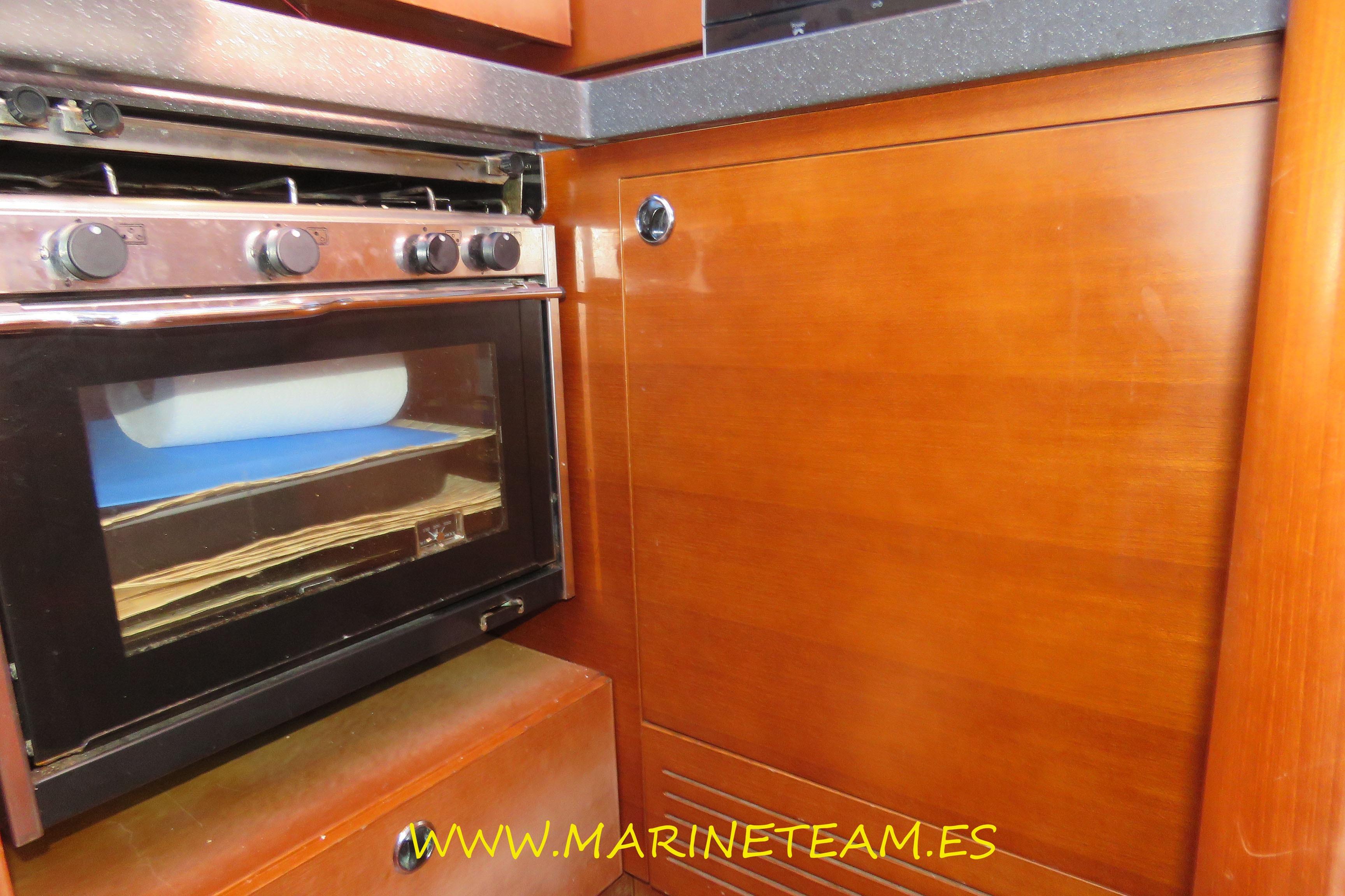 Shipman 50 yacht kitchen with wooden cabinetry and stainless steel oven, 2005 model.