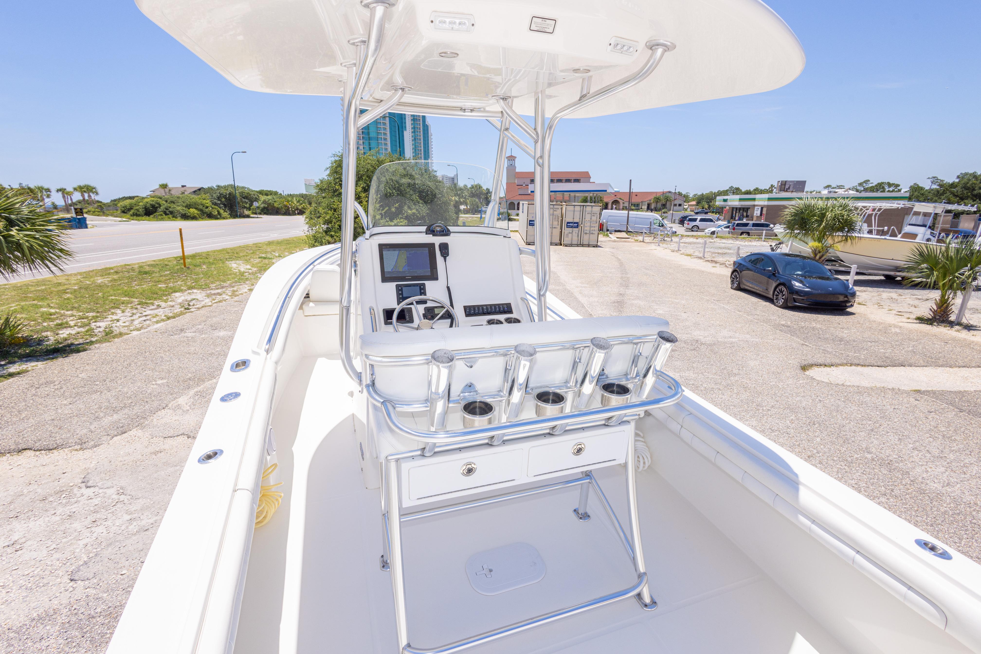 2019 Regulator 23 Center Console boat with sleek design, parked near a coastal road.