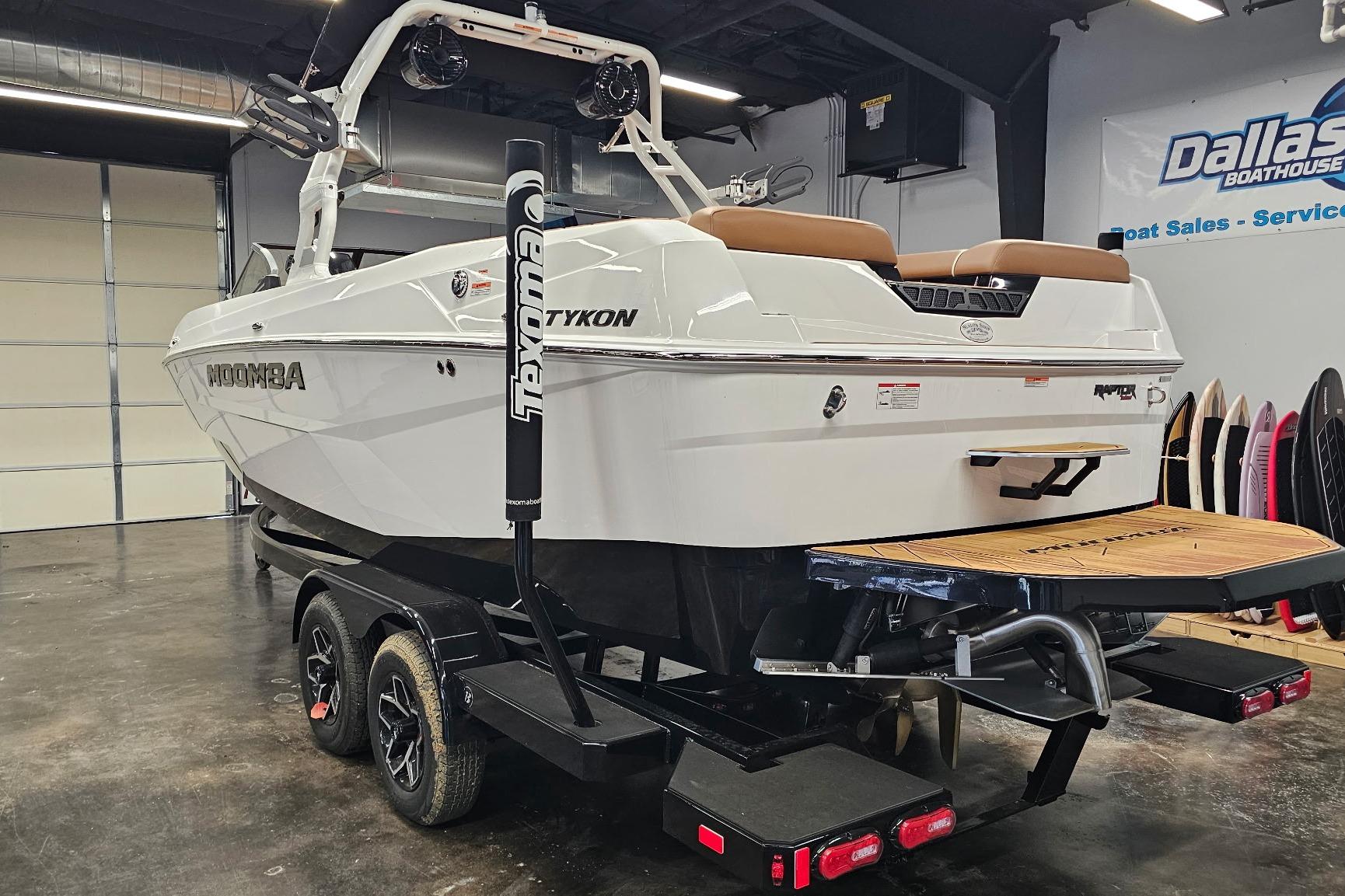 2026 Moomba Tykon boat in showroom, featuring sleek design and modern amenities.