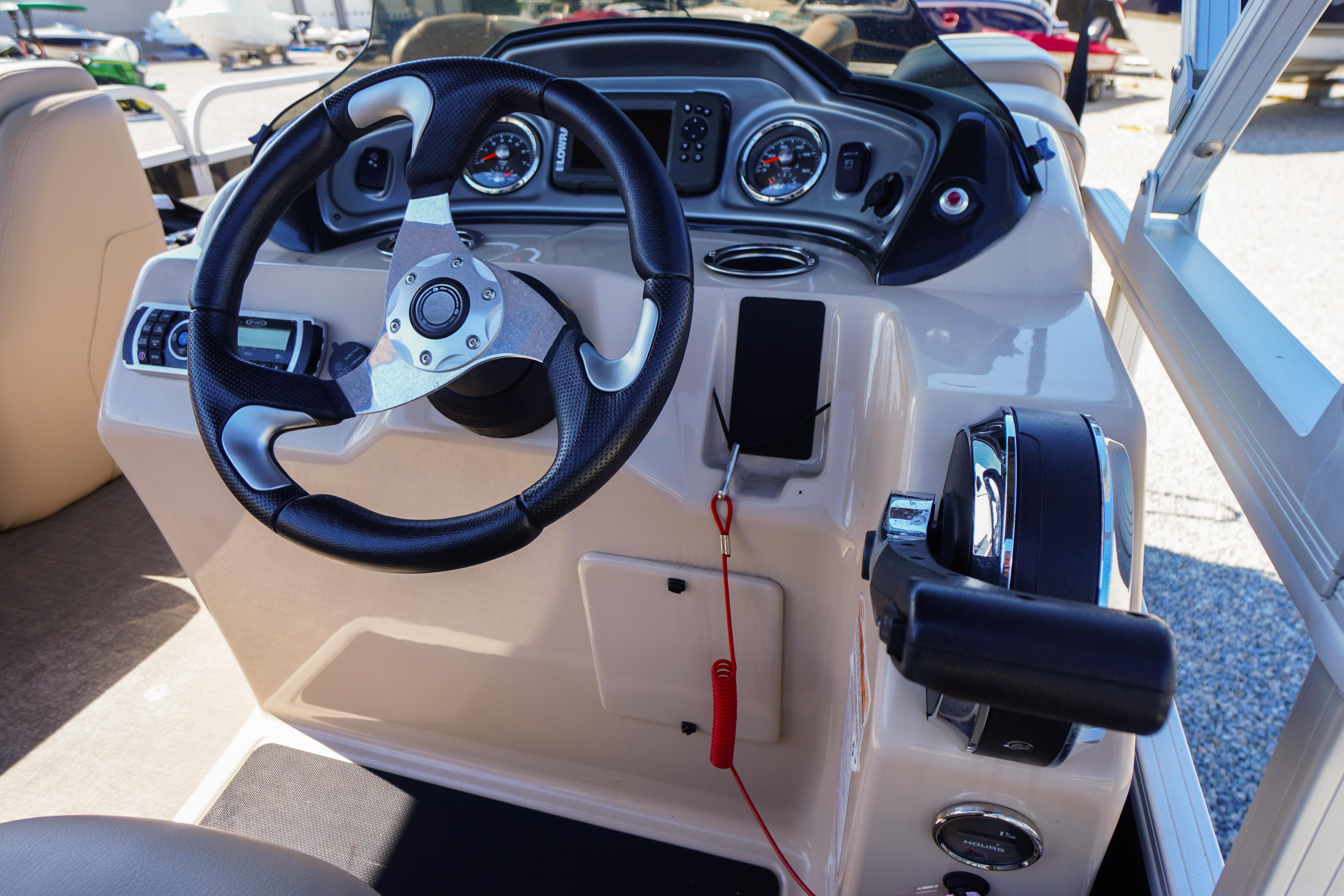 2019 SUNTRACKER Fishin' Barge 22 DLX dashboard with steering wheel and controls.