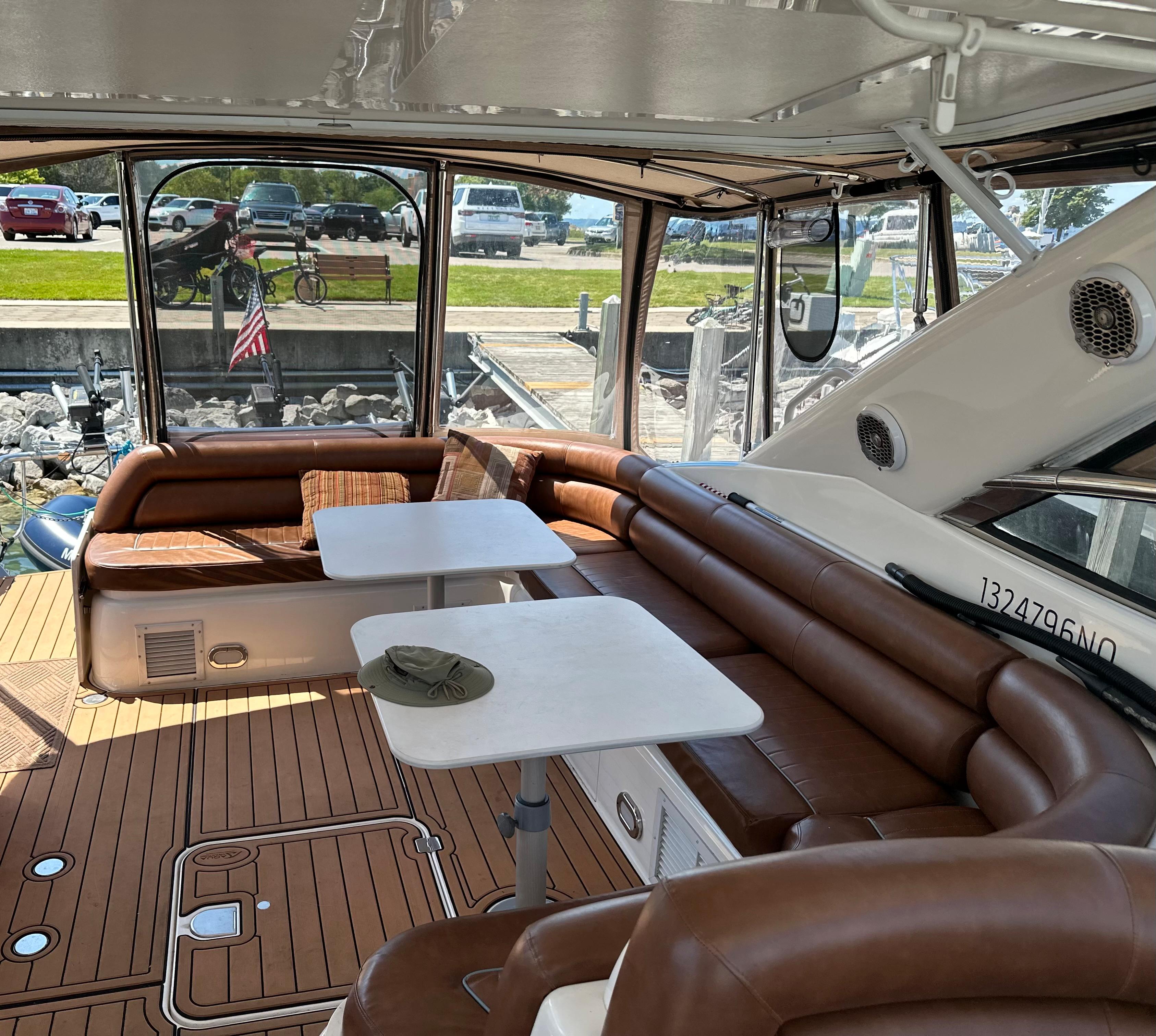 1997 Sunseeker Camargue yacht interior with brown seating and white tables.