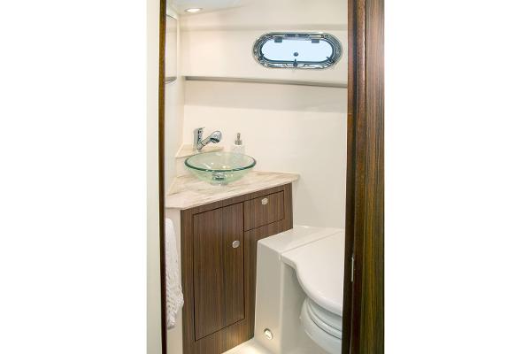 Manufacturer Provided Image: 2021 Pursuit OS 325 Offshore boat bathroom with modern sink and toilet.