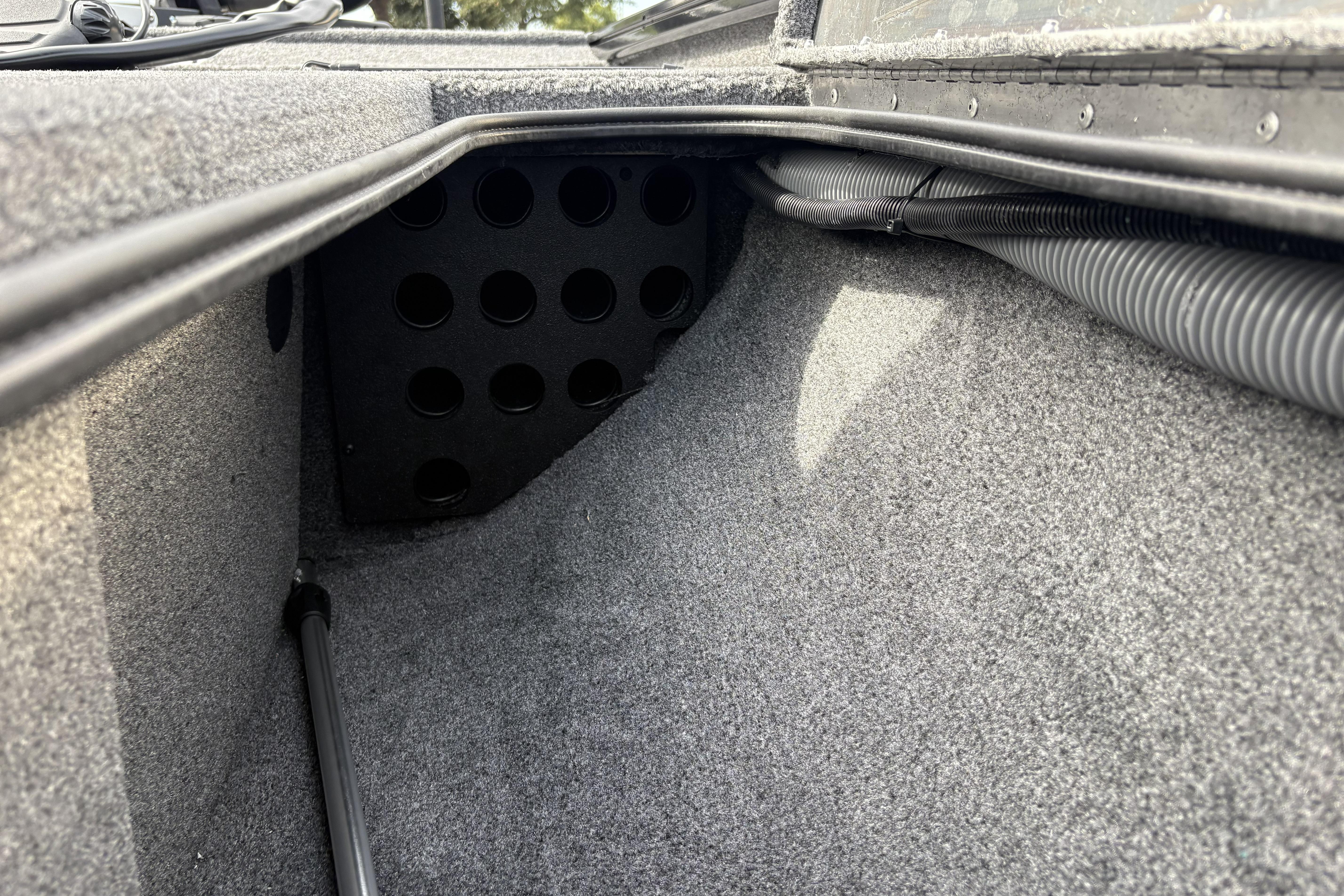 Interior view of 2026 Tracker Pro Team 195 boat storage compartment with carpeted finish.