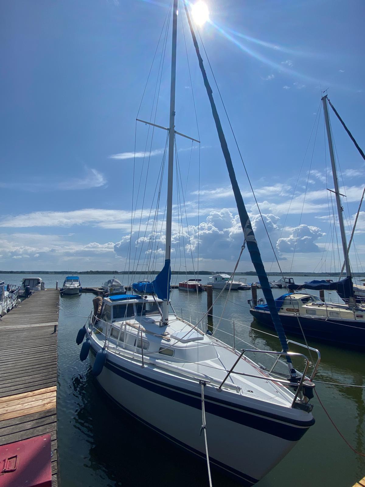 Sailboat docked under sunny sky, LM 32 model, 1980.