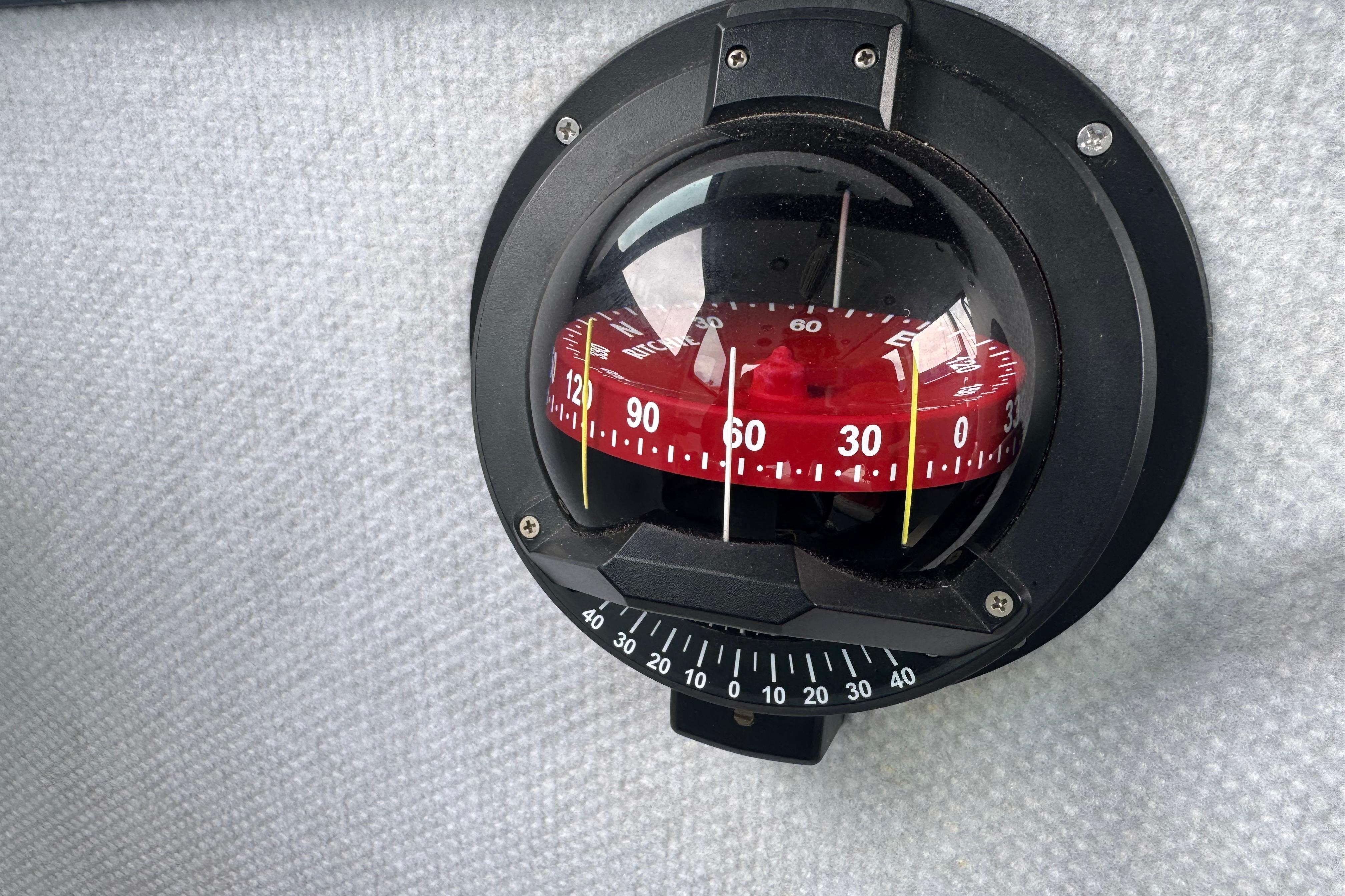 Compass on a textured surface, ACB model 30, year 2003.