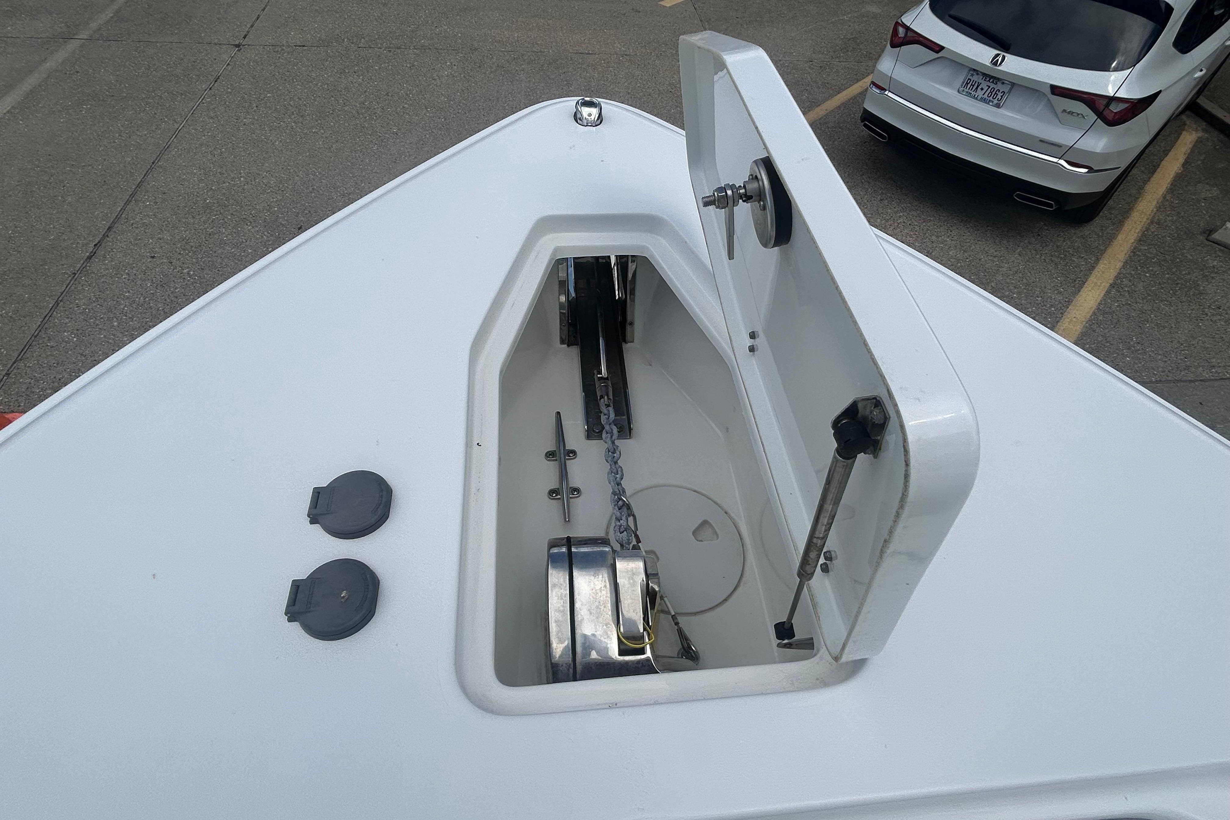 2023 Sea Hunt Gamefish 27 Coffin Box anchor compartment, open lid, showing chain and mechanism.