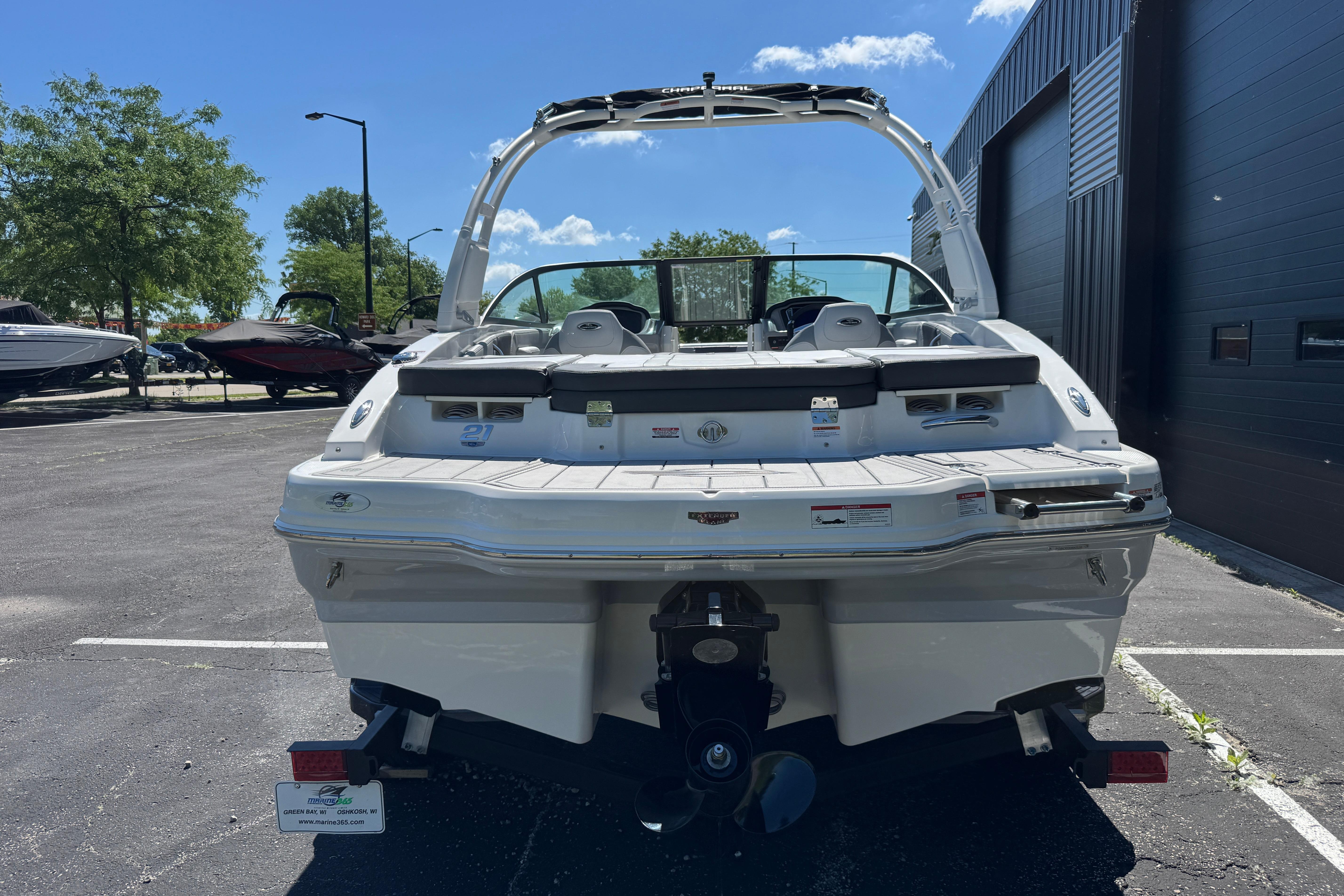 2026 Chaparral 21 SSi boat rear view in parking lot, sunny day.