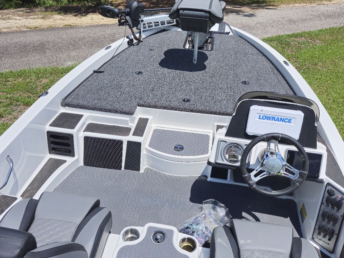 The image shows the cockpit of a 2021 Caymas CX 18 SS boat with gray seating and a steering wheel.