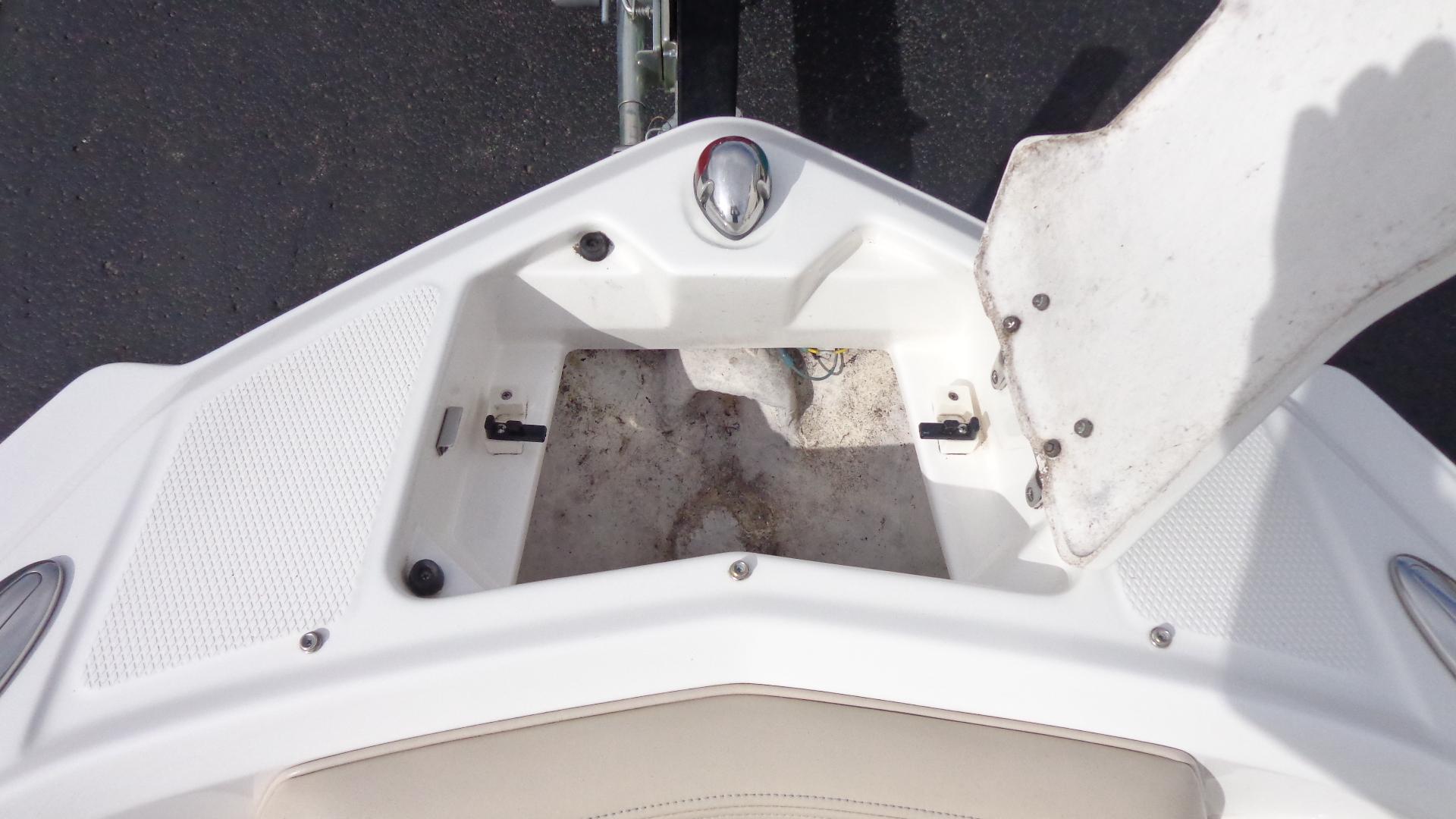 Open storage compartment on a 2011 Chaparral 206 SSi boat.