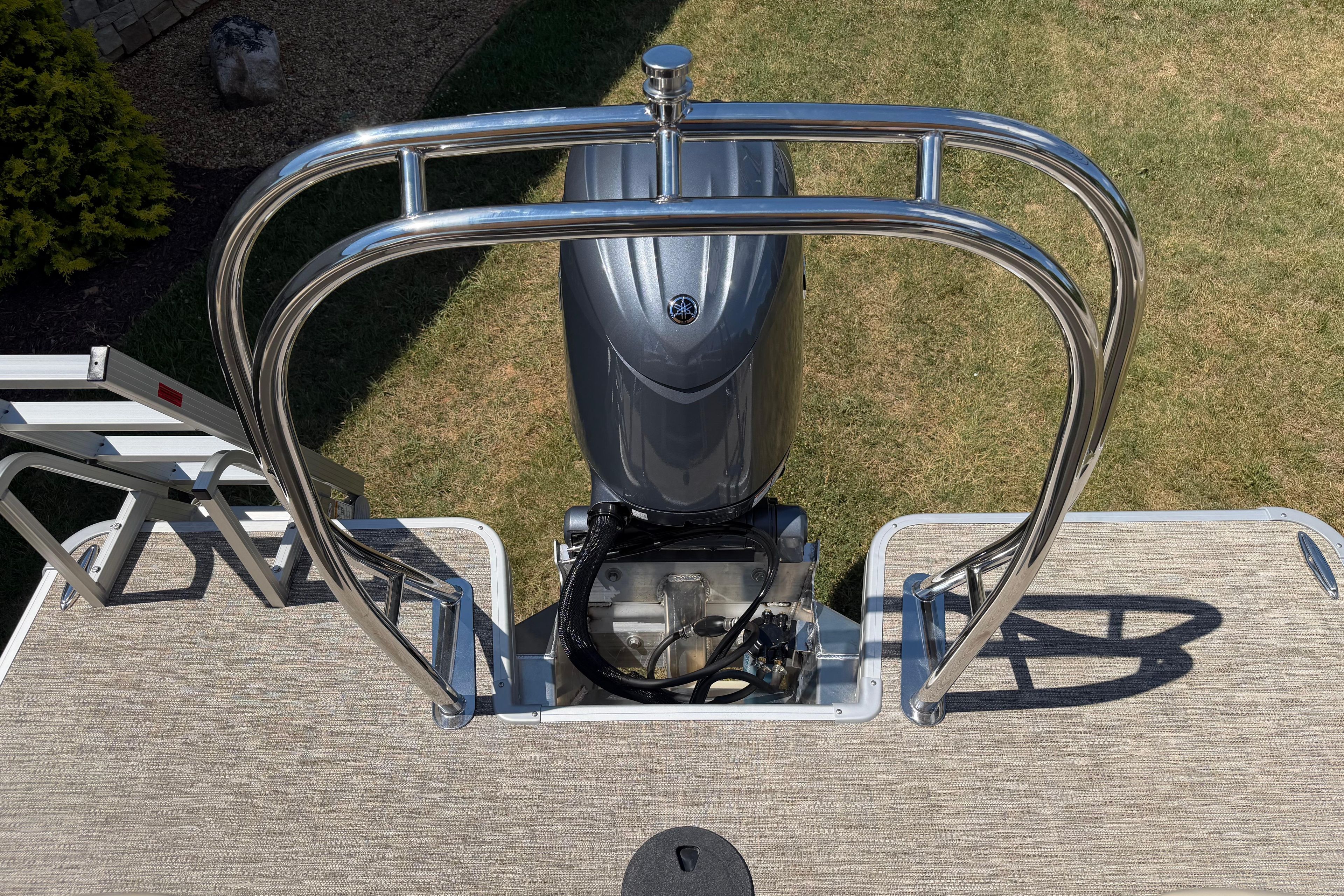 Rear view of a 2026 Godfrey SW 2086 SBC boat engine with stainless steel railing.