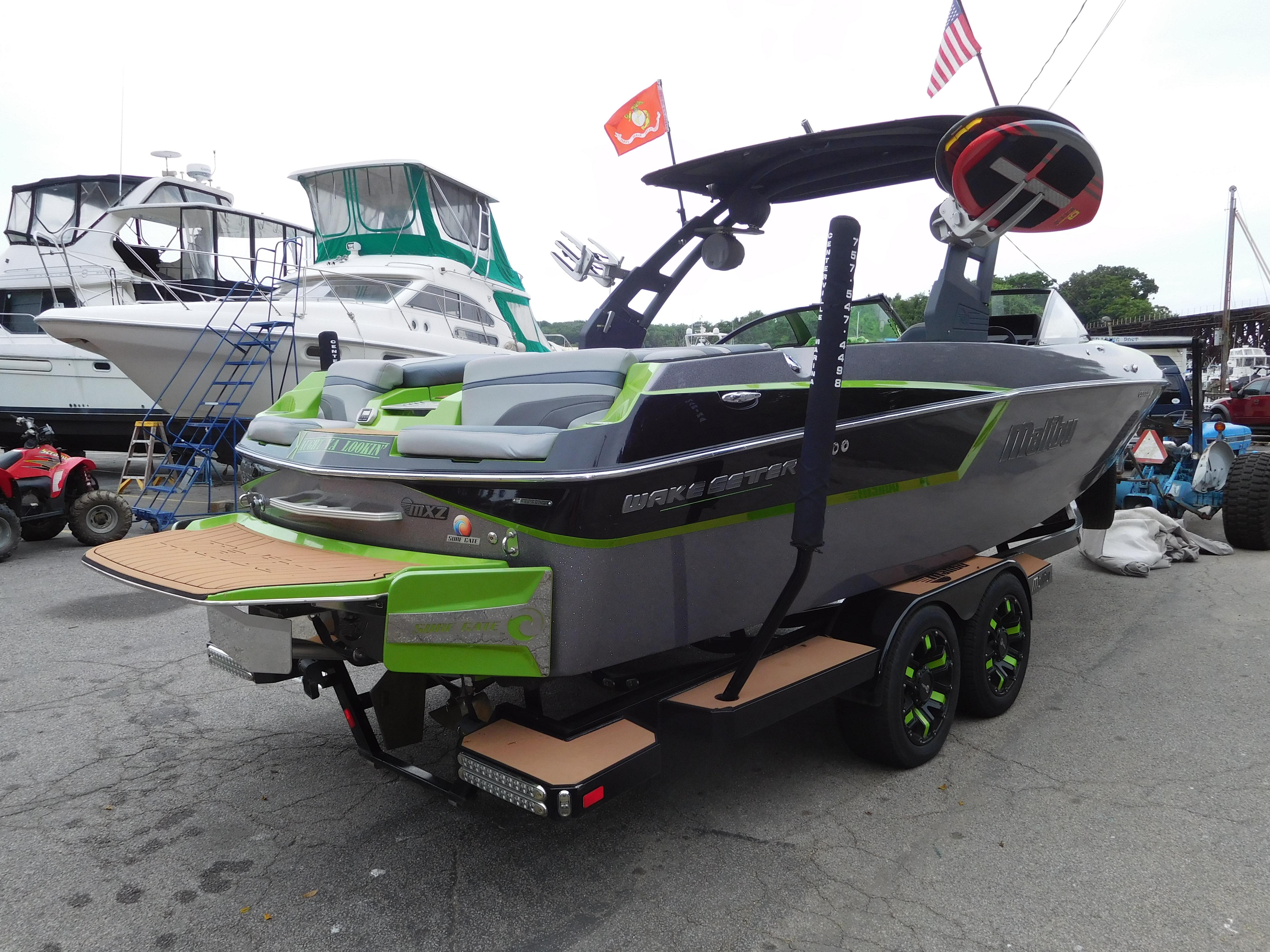 2017 Malibu Wakesetter 24 MXZ boat on trailer at marina.