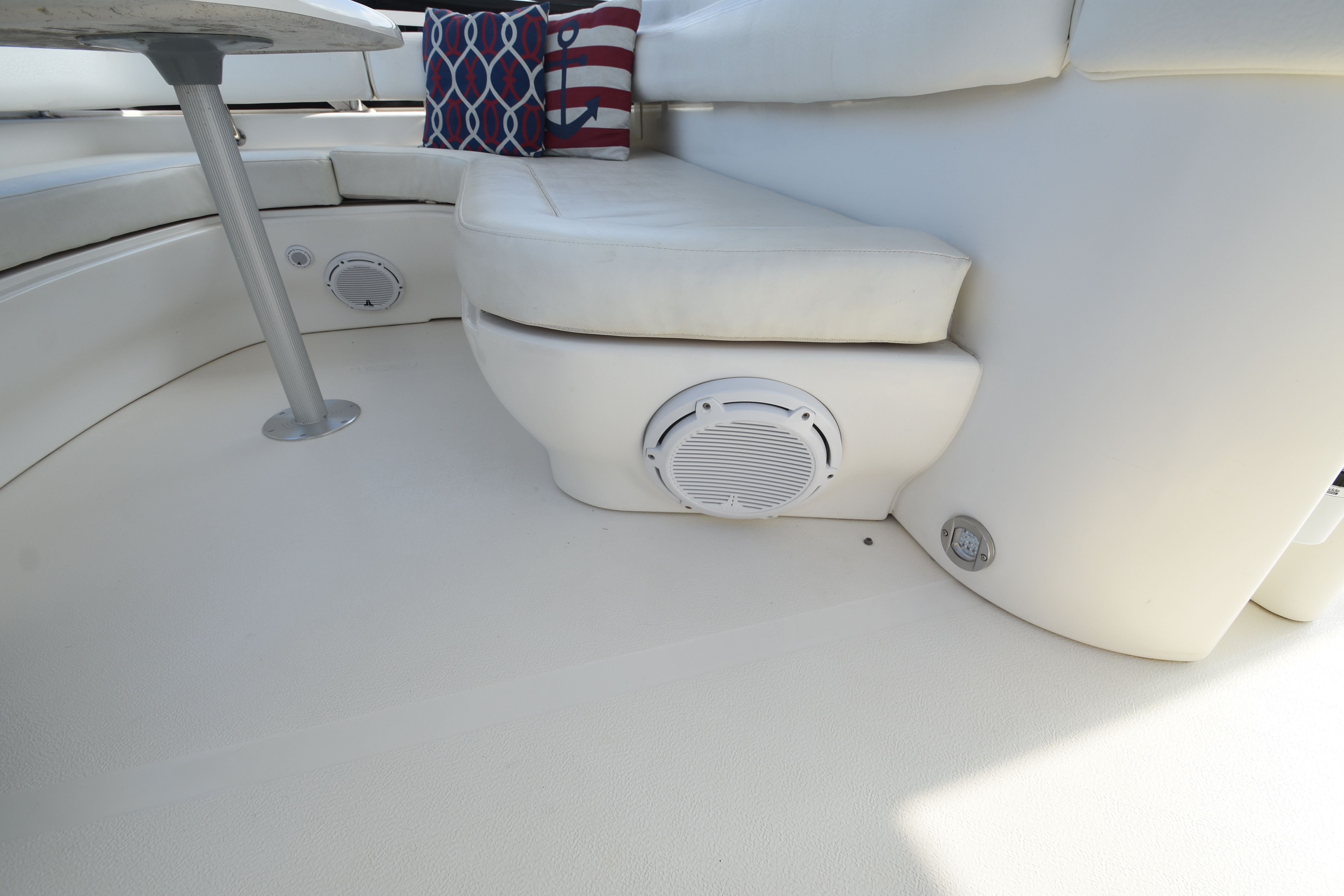 Interior of the Sea Ray 480 Sedan Bridge with white seating and a speaker.