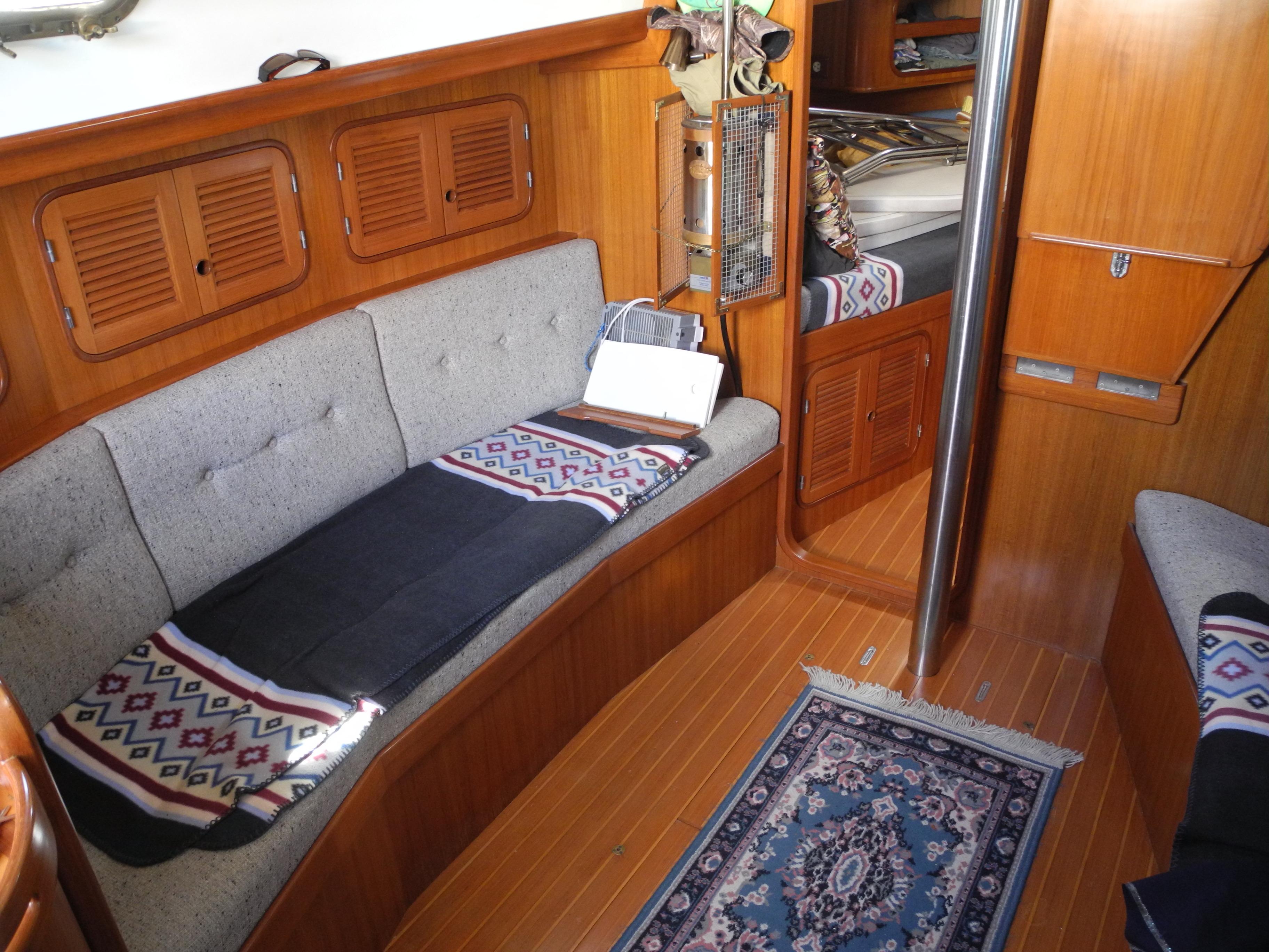 Interior of 1987 Ta Shing Tashiba 31 sailboat with cozy seating and wooden finishes.