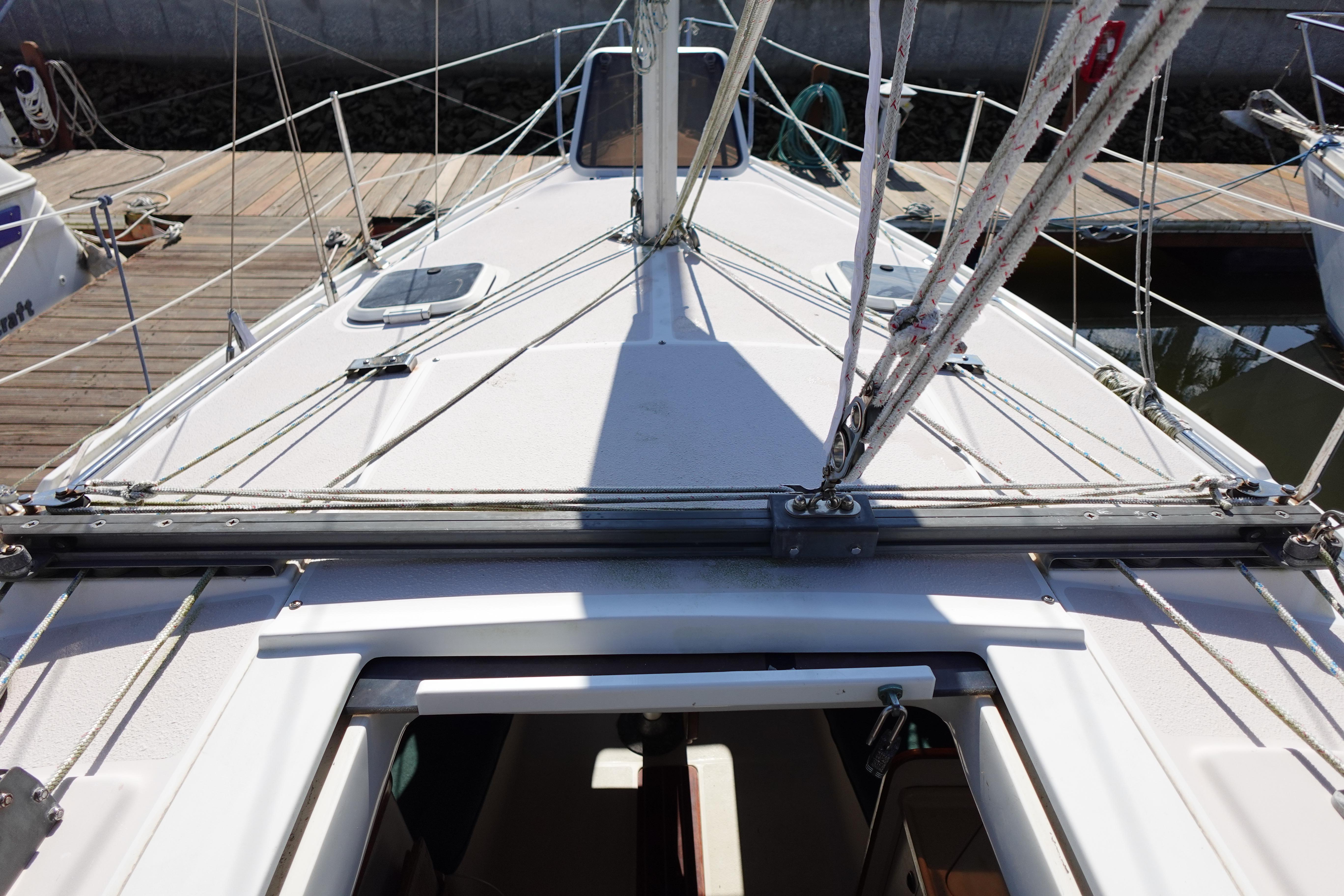 Deck view of a 1997 Catalina 28 sailboat docked at a marina.