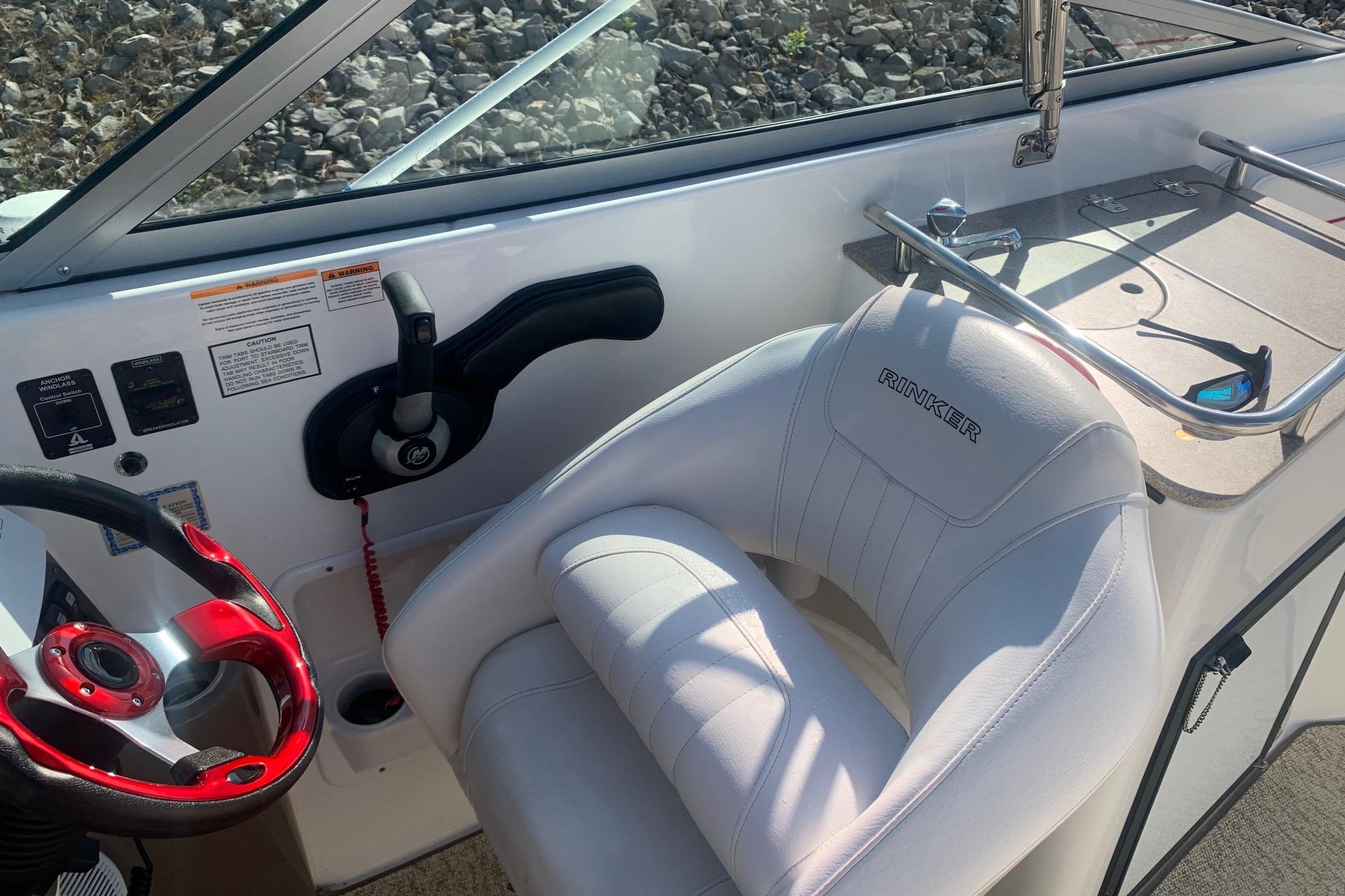 Interior of 2006 Rinker 282 Captiva Cuddy boat with steering wheel and controls.