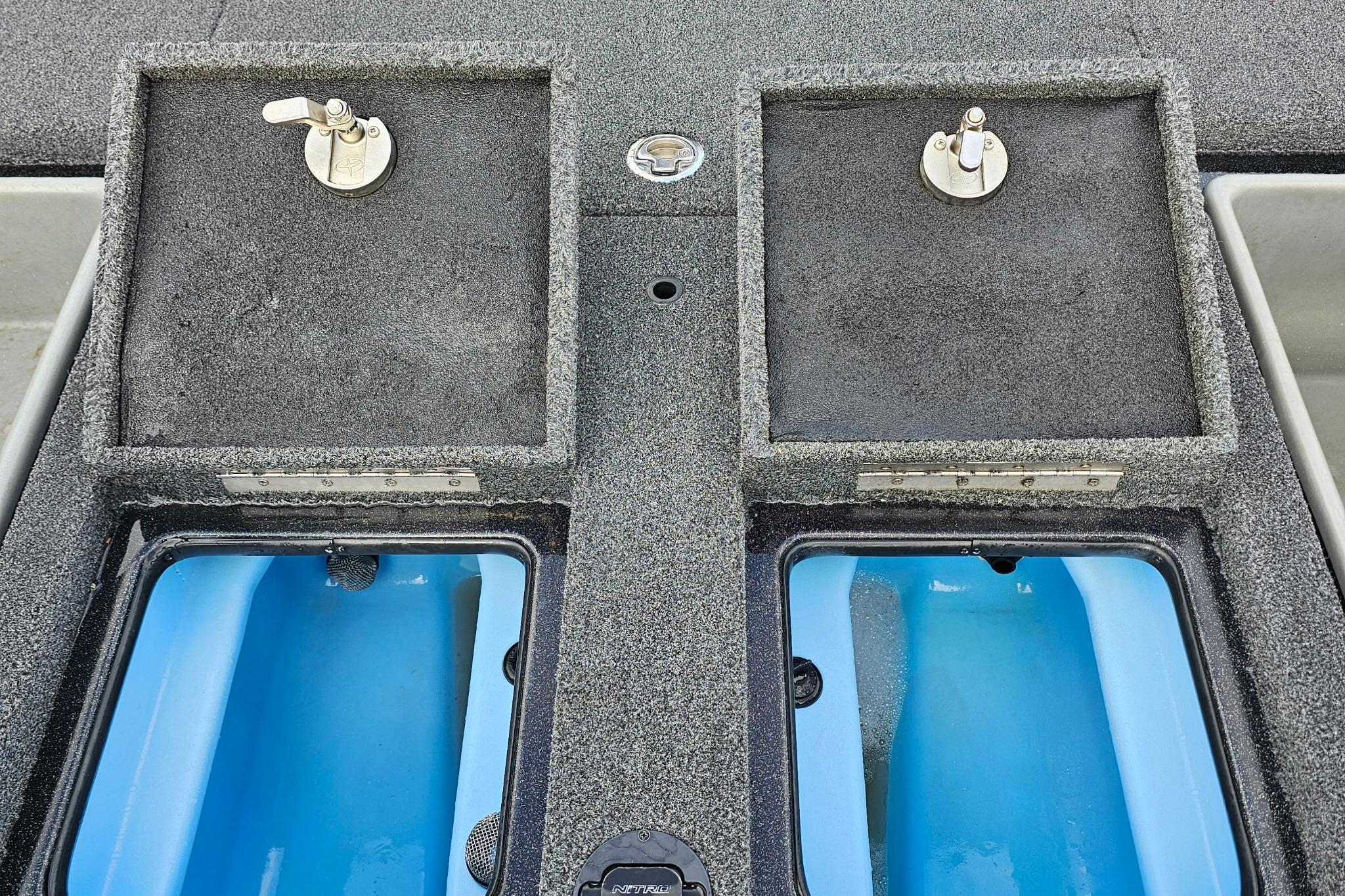 Nitro Z20 Pro 2017 boat livewell compartments with blue interior and secure latches.