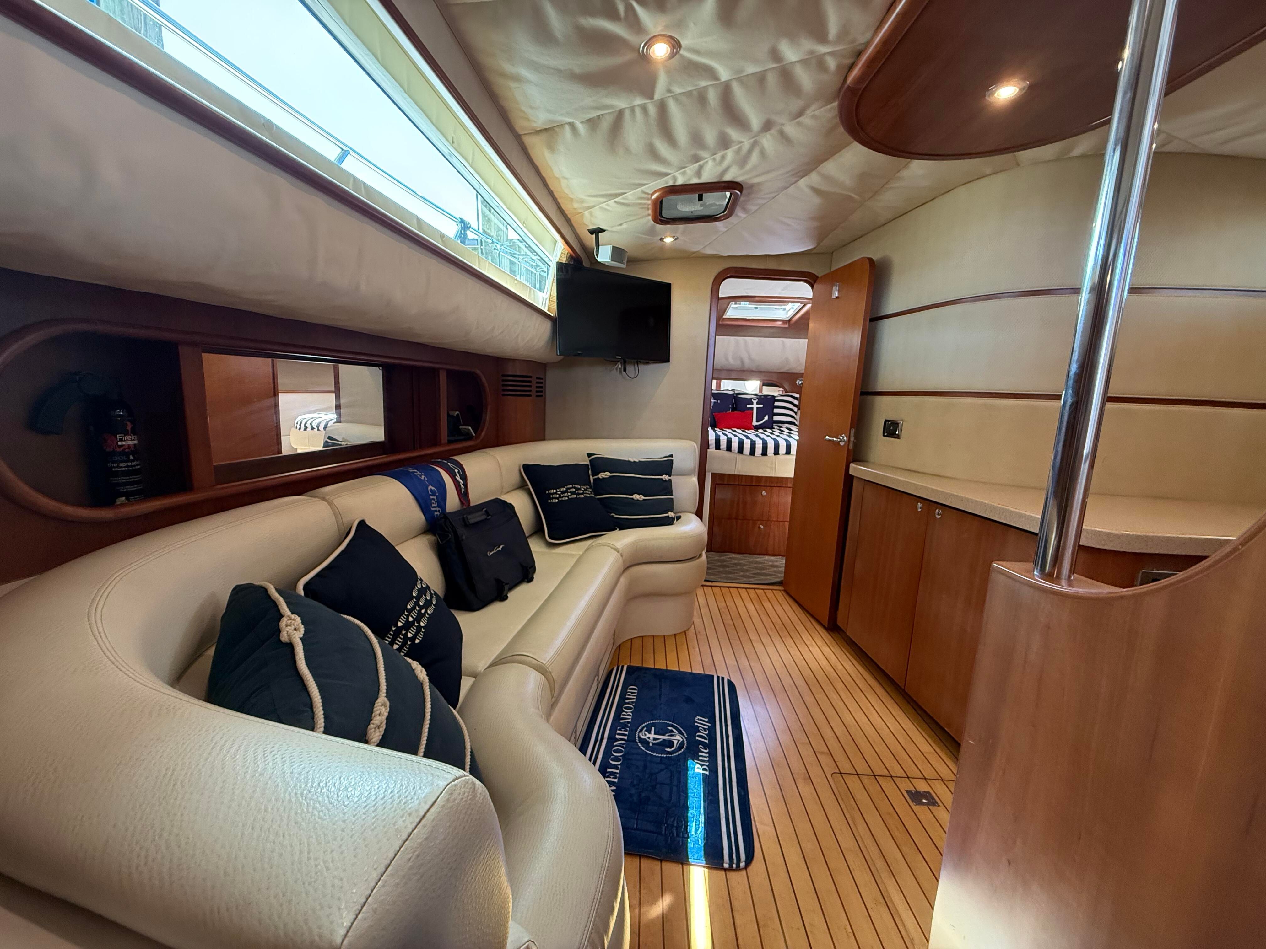 Interior of the 2007 Chris-Craft Roamer 40 with elegant leather seating and wooden floors.