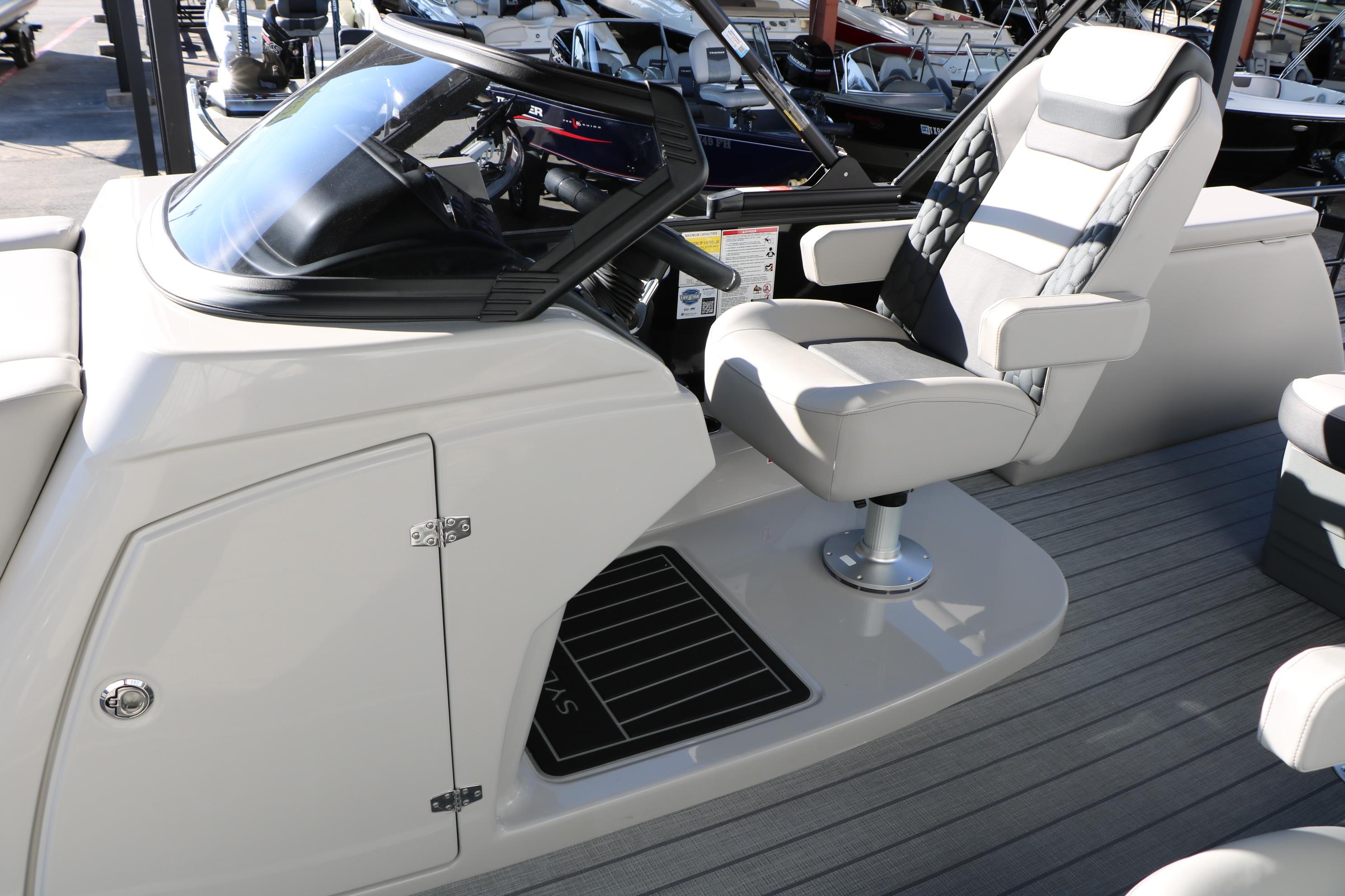 2026 Sylvan L3 CLZ DH boat interior with captain's chair and dashboard.