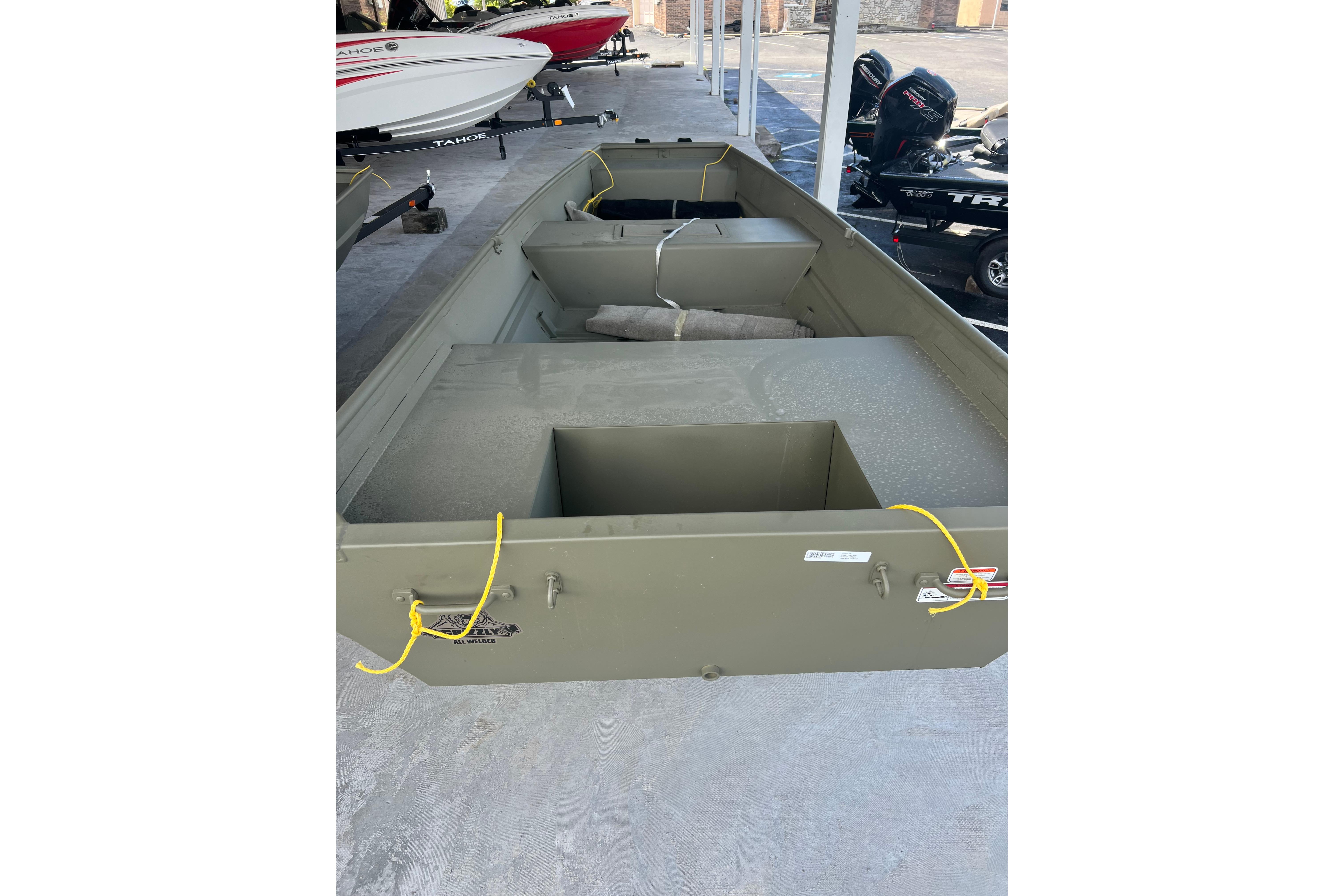 2026 Tracker Grizzly 10 Jon boat, olive green, displayed in a showroom.