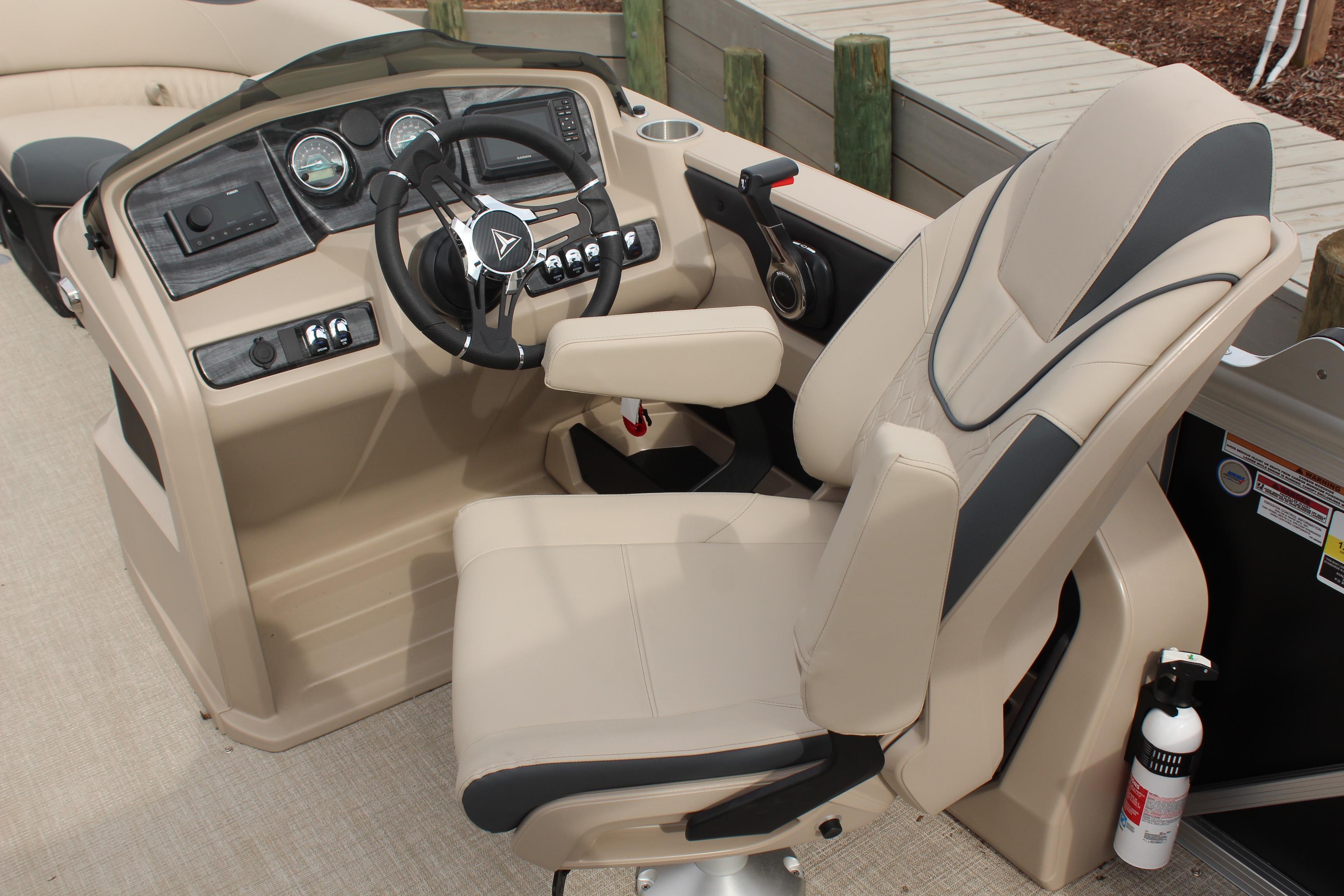 2026 Tahoe Pontoon LTZ helm with beige captain's chair and modern dashboard controls.