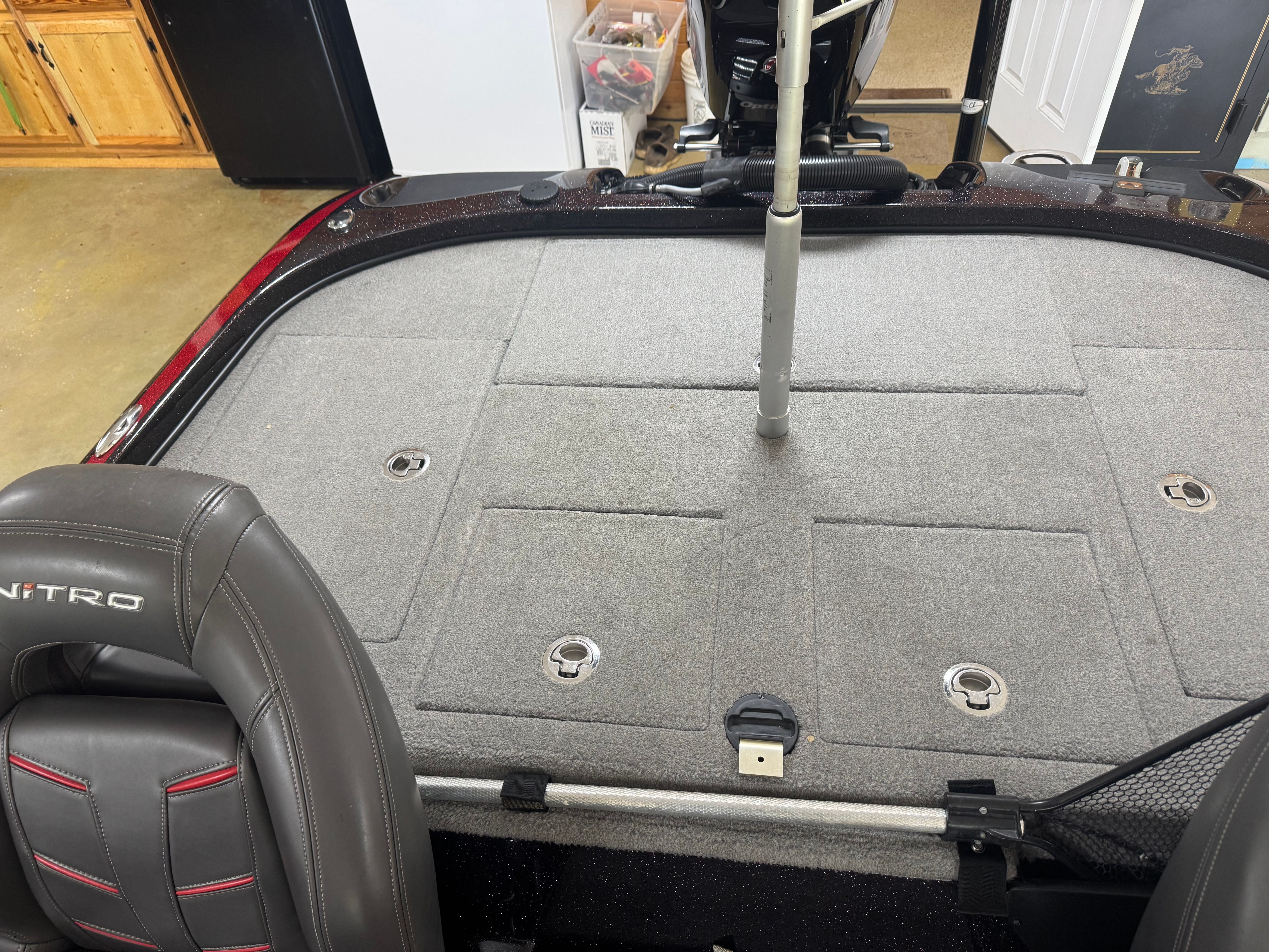 The image shows the deck of a Nitro Z21 boat with gray carpeting.