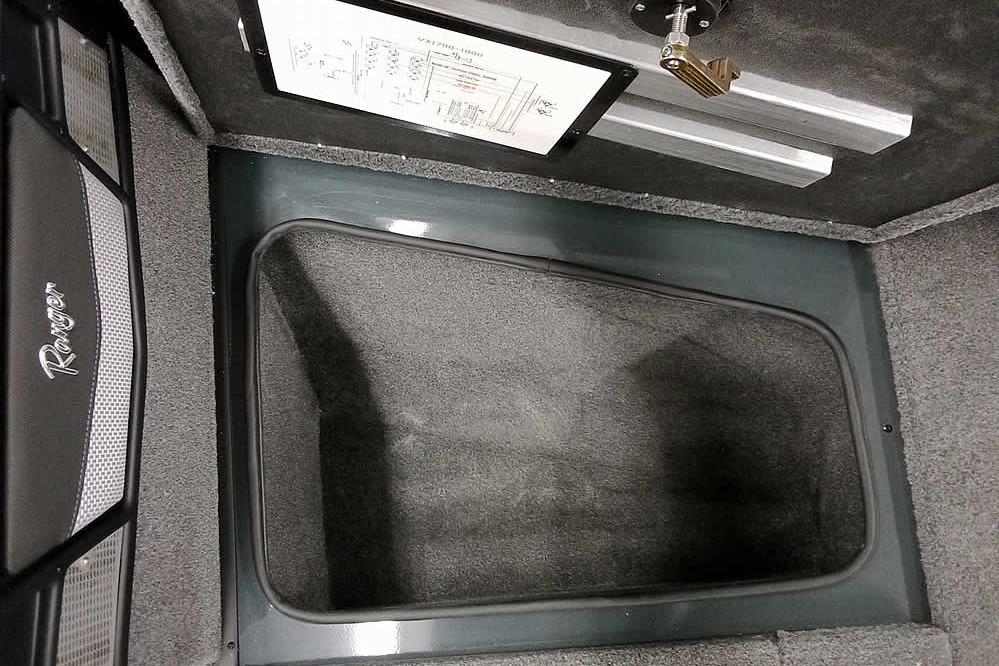 Interior storage compartment of 2026 Ranger VX1888 WT boat, featuring carpeted finish and secure latch.