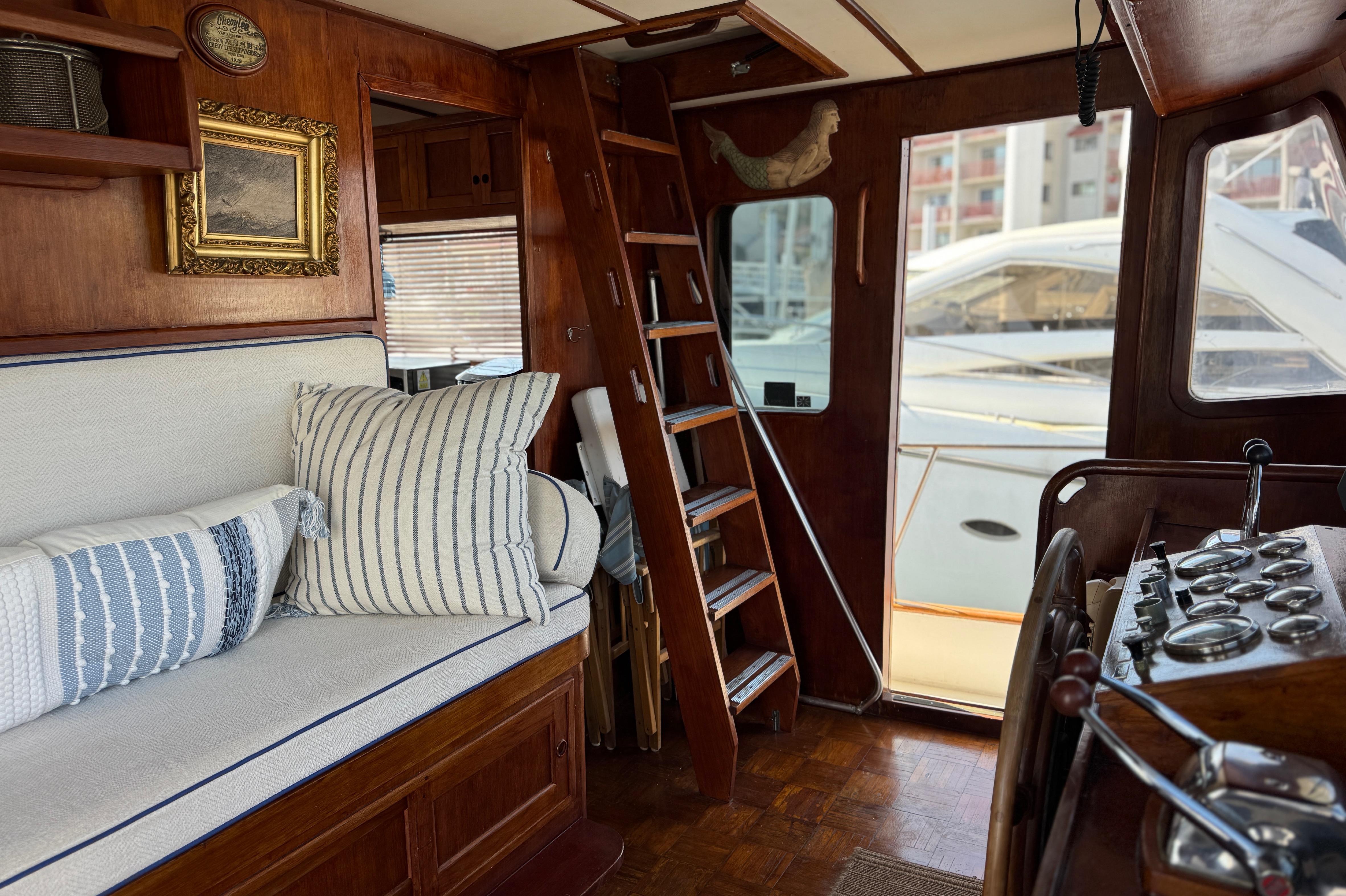 Interior of 1979 Cheoy Lee 46 LRC yacht with wooden decor and nautical accents.