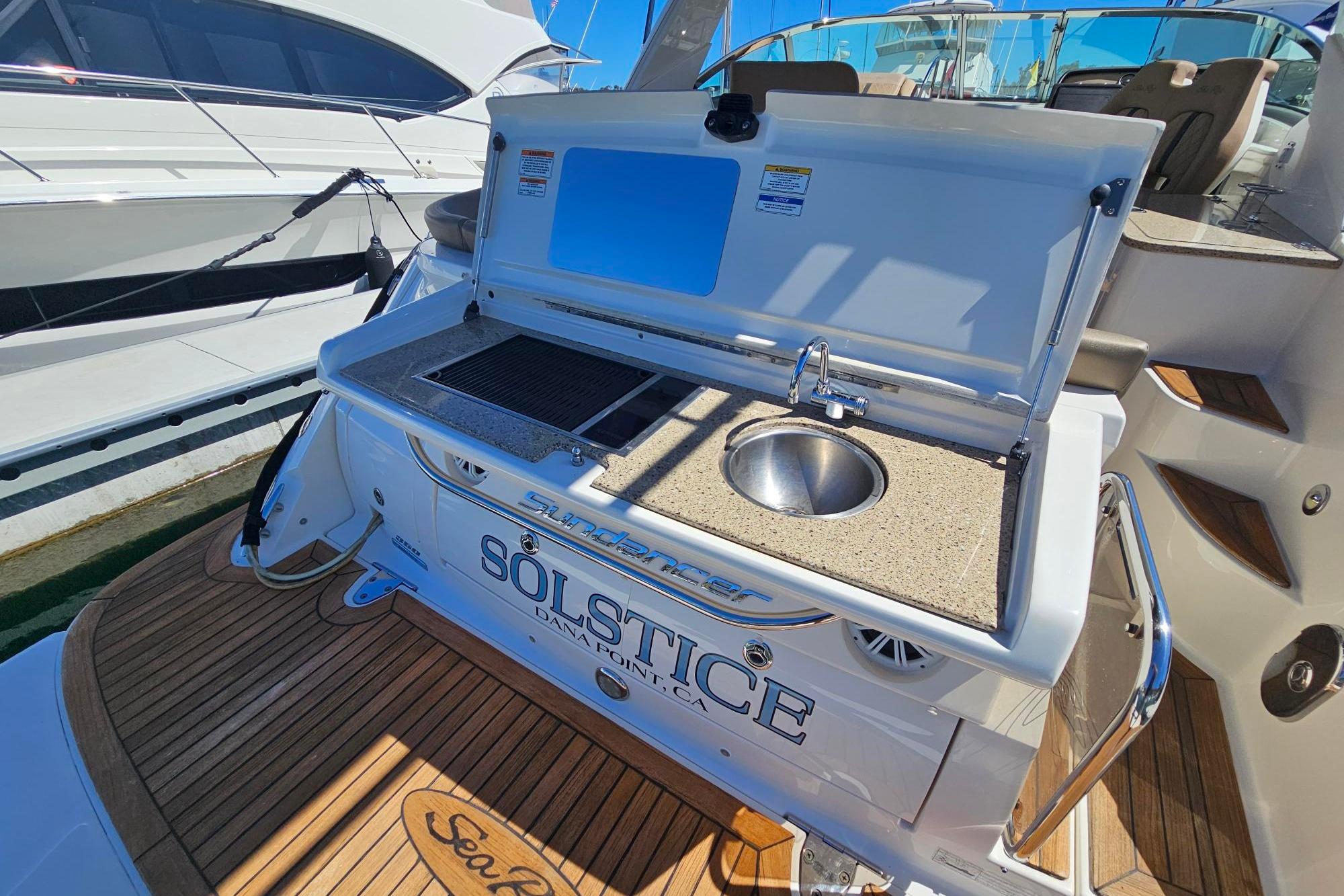 2016 Sea Ray Sundancer 350 yacht with outdoor kitchenette and sink on deck.