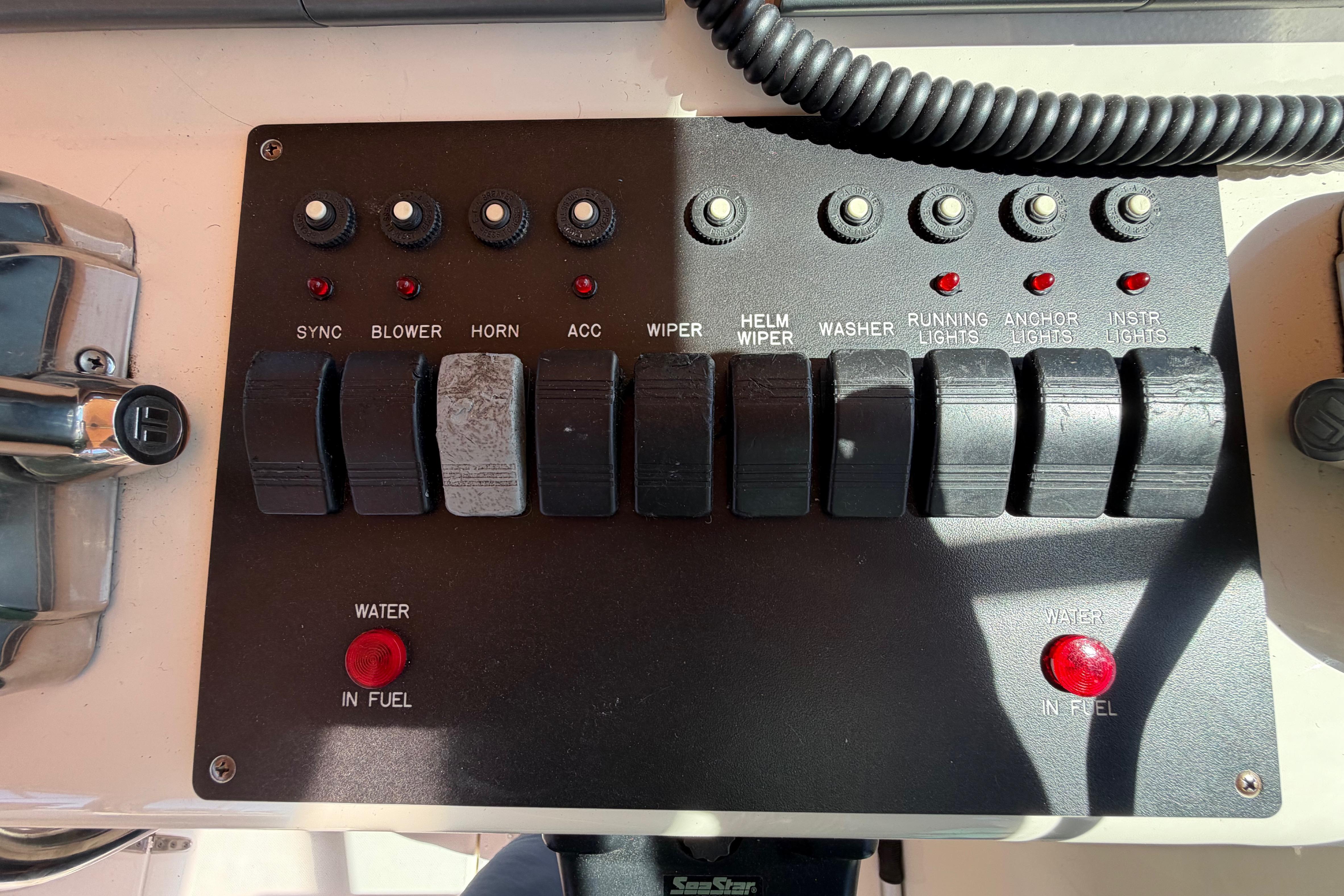 Control panel of a 2000 Sabreline 36 Express boat with various switches and indicators.