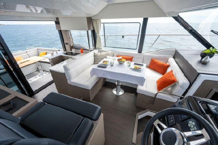 Luxurious interior of 2024 Jeanneau NC 1295 Fly yacht with elegant dining area.