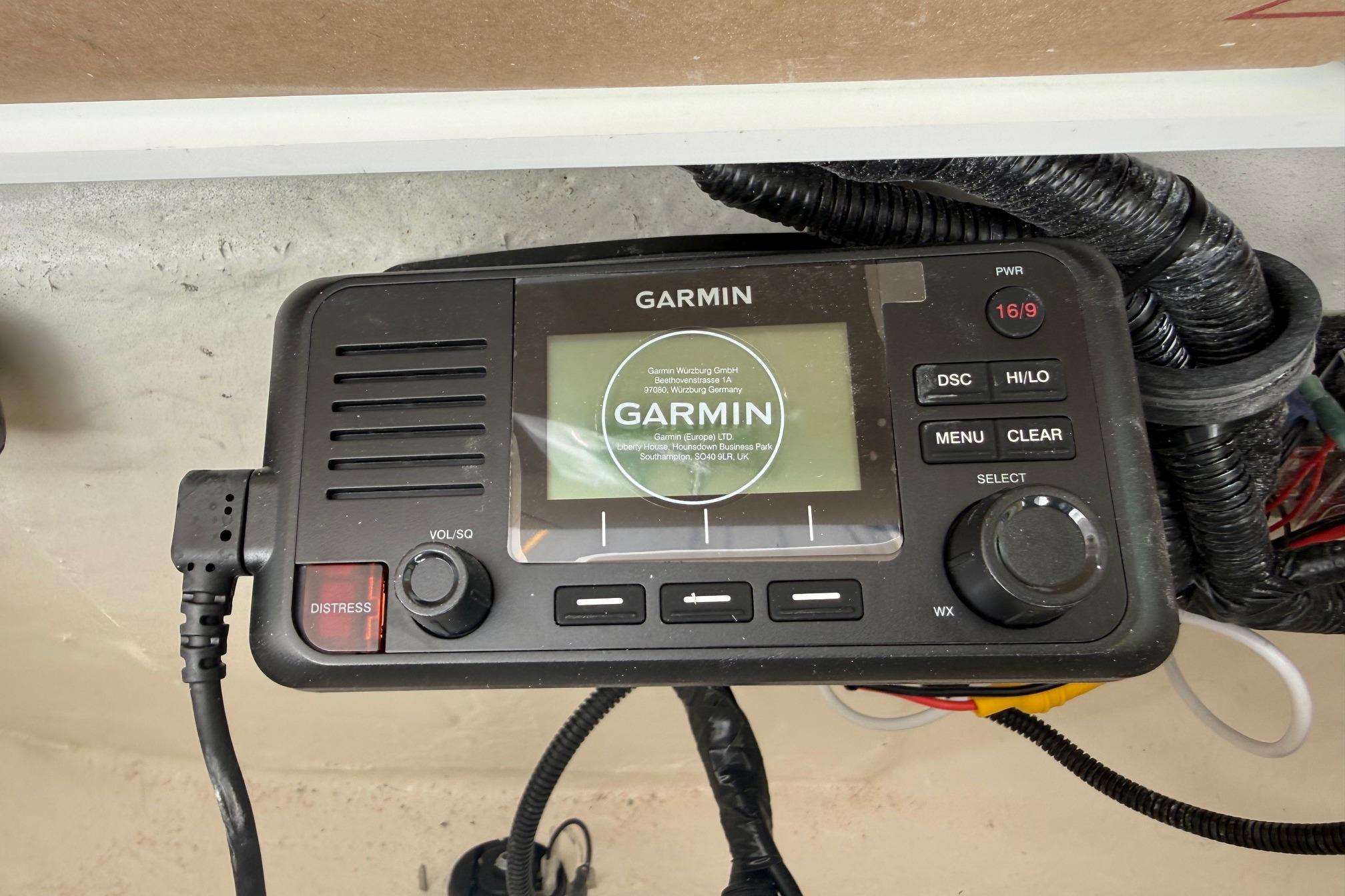 Garmin marine radio on 2026 Sea Hunt Ultra 229 boat, featuring distress button and display.