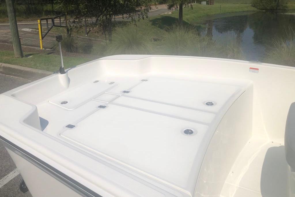 2026 Mako Pro Skiff 17 CC boat deck, parked near a pond.